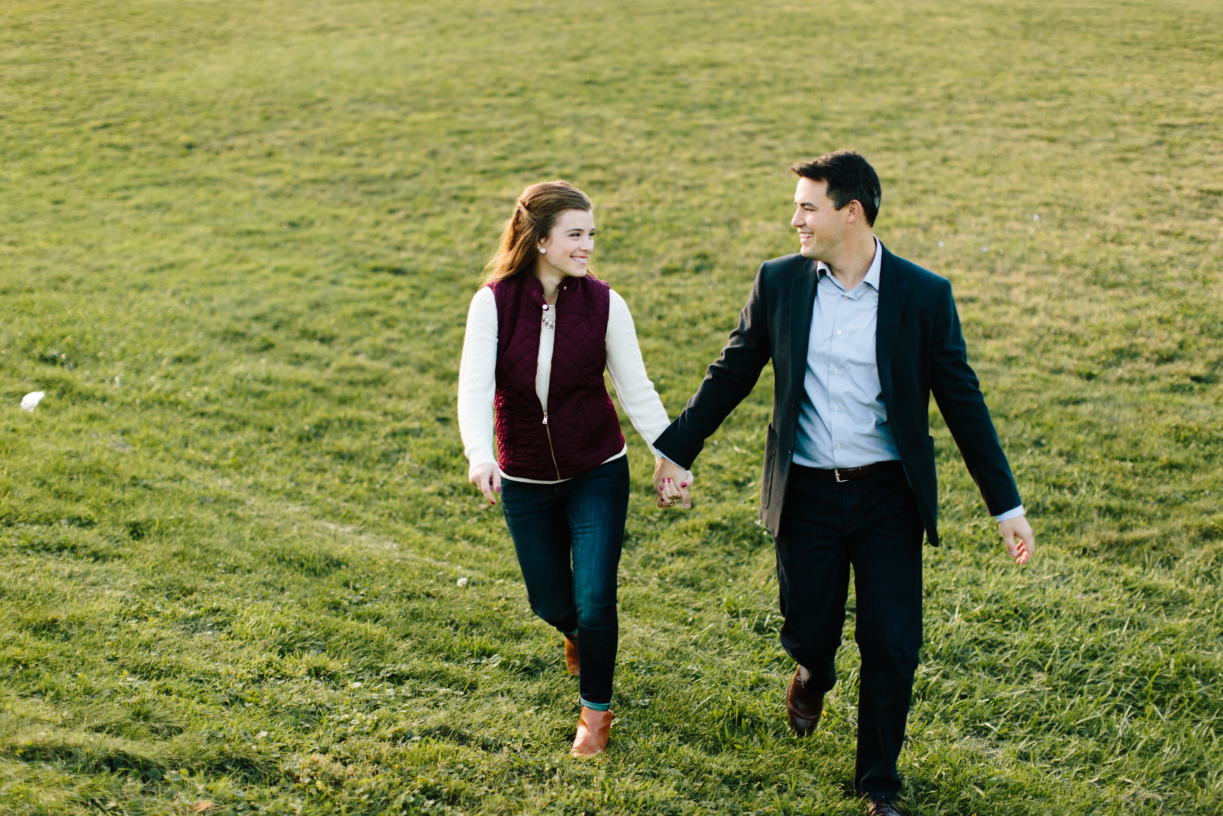 couple running in field engagement session 