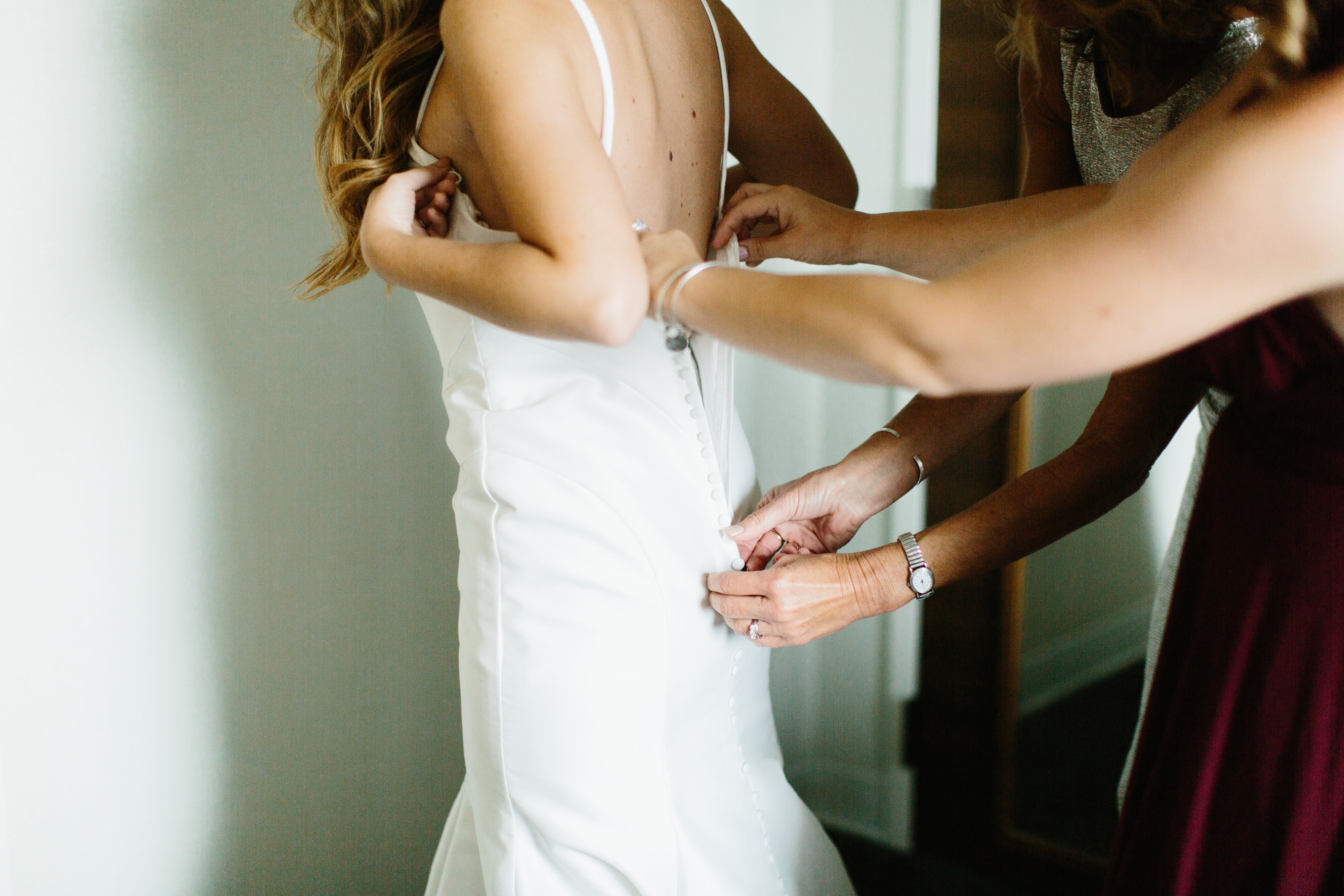 bridal dress getting zipped