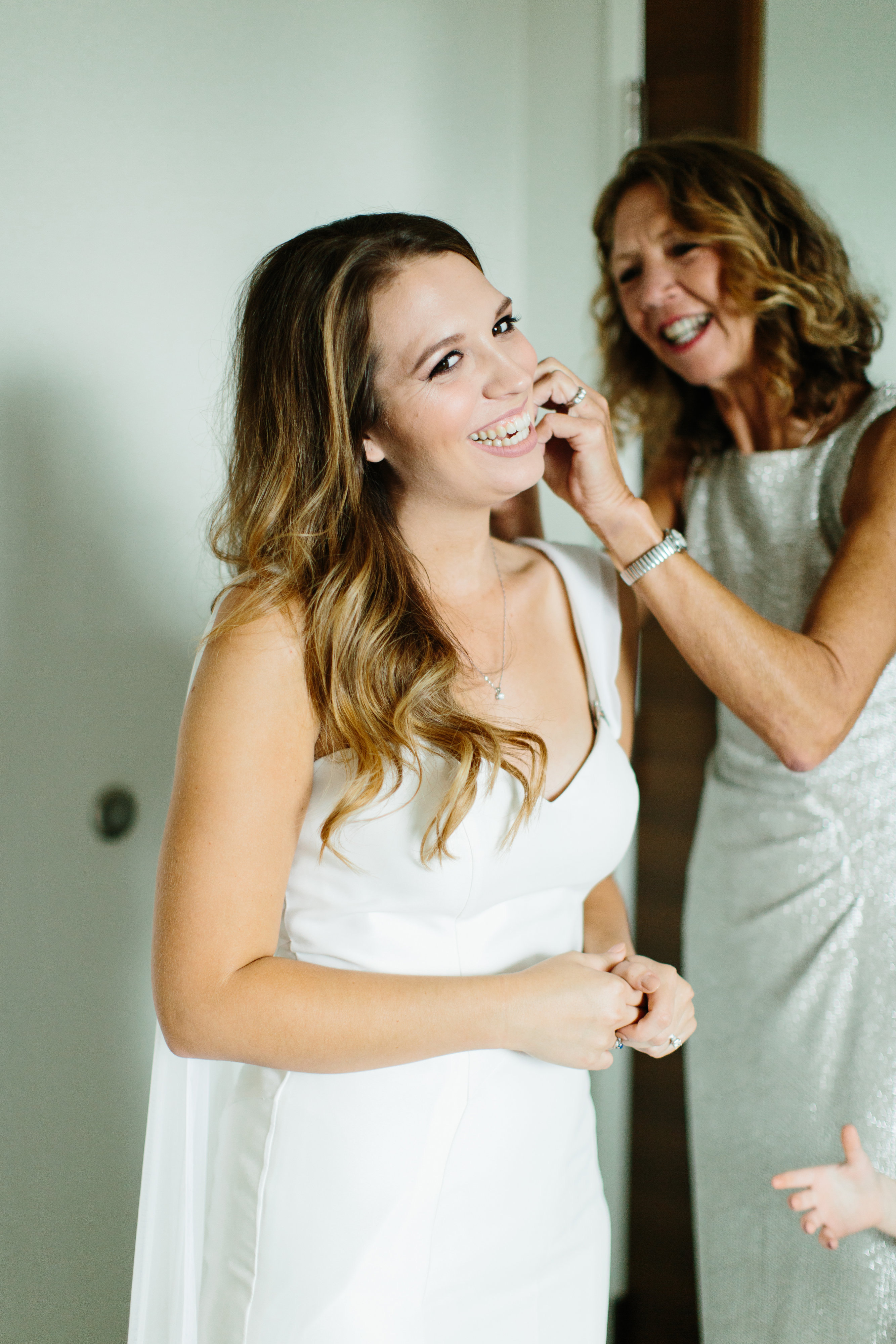 smiling bride as getting the finishing touches