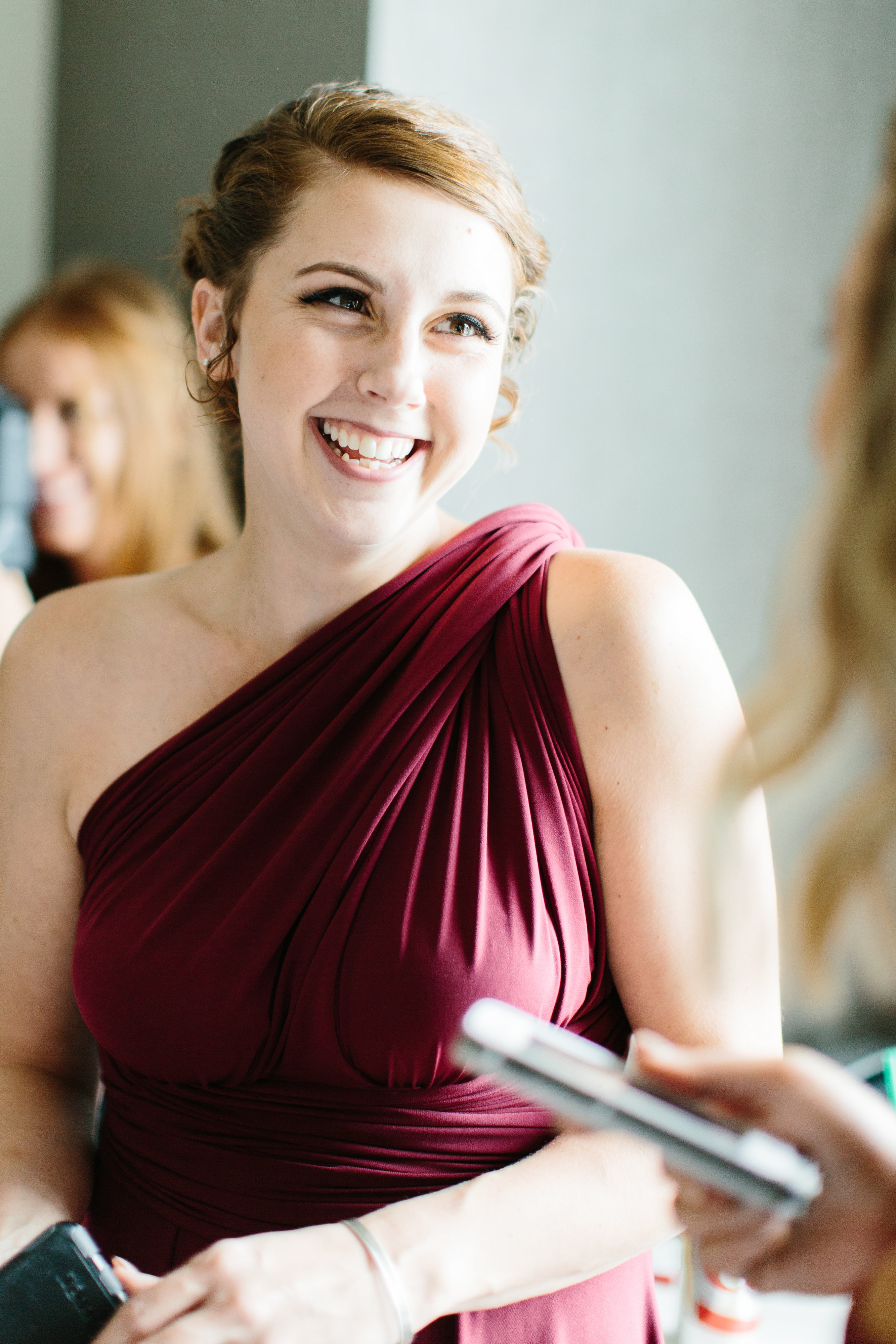 bridesmaid smiling in maroon dress