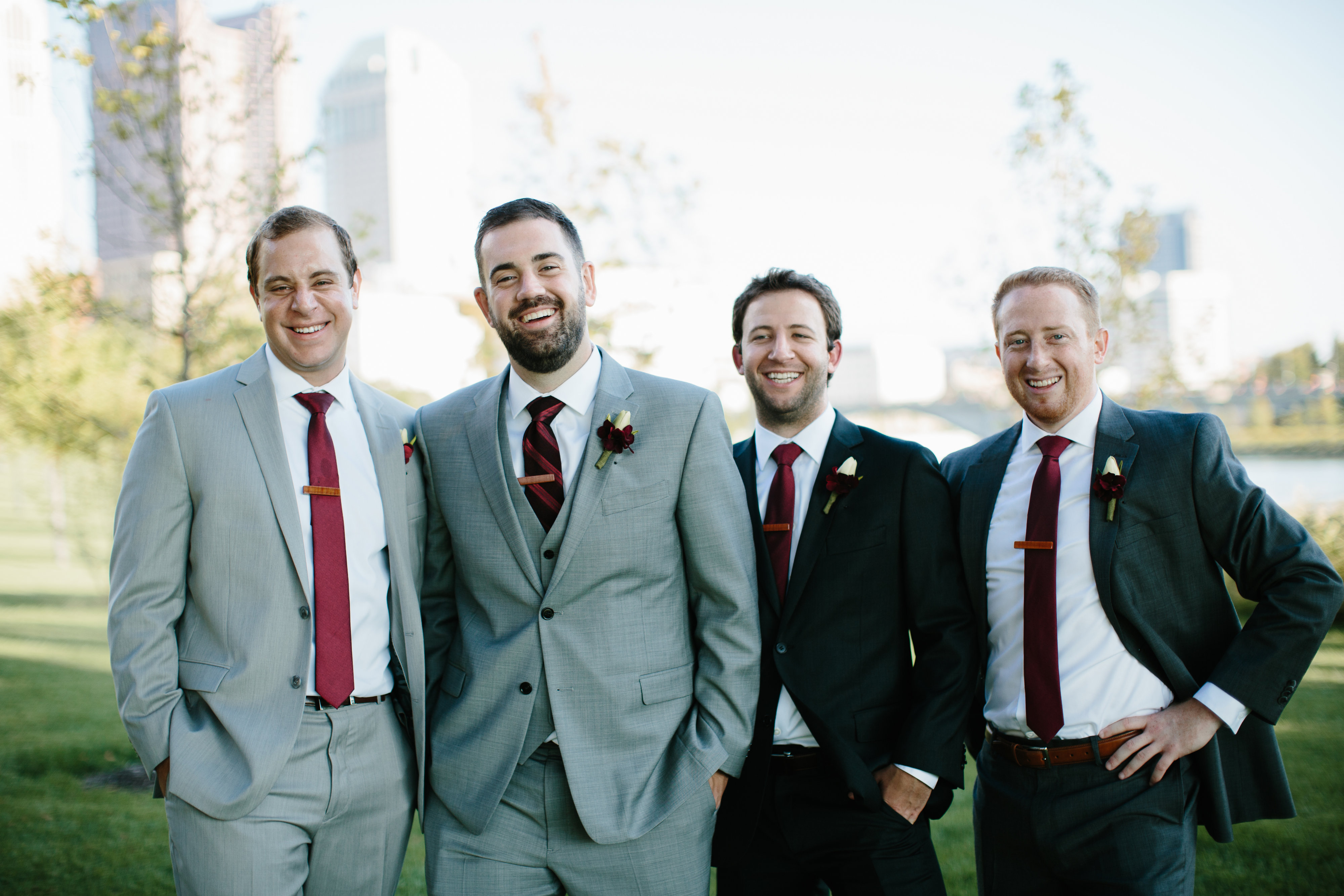 groomsmen in grey suits and maroon ties