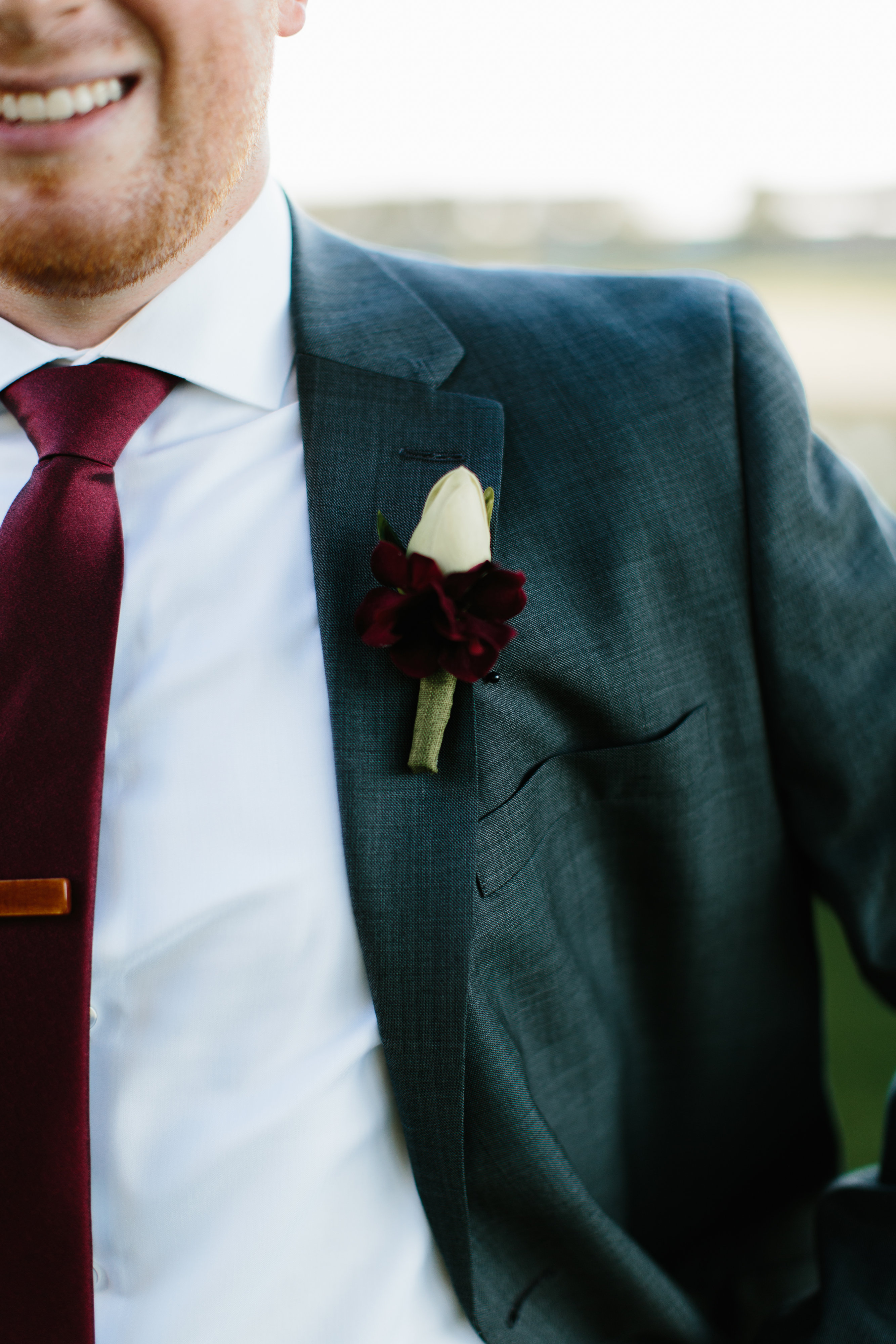 maroon tie in grey suit