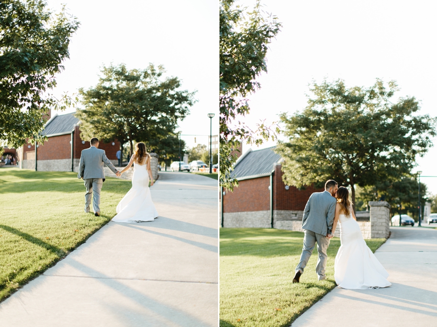 bride and groom holding hands walking away