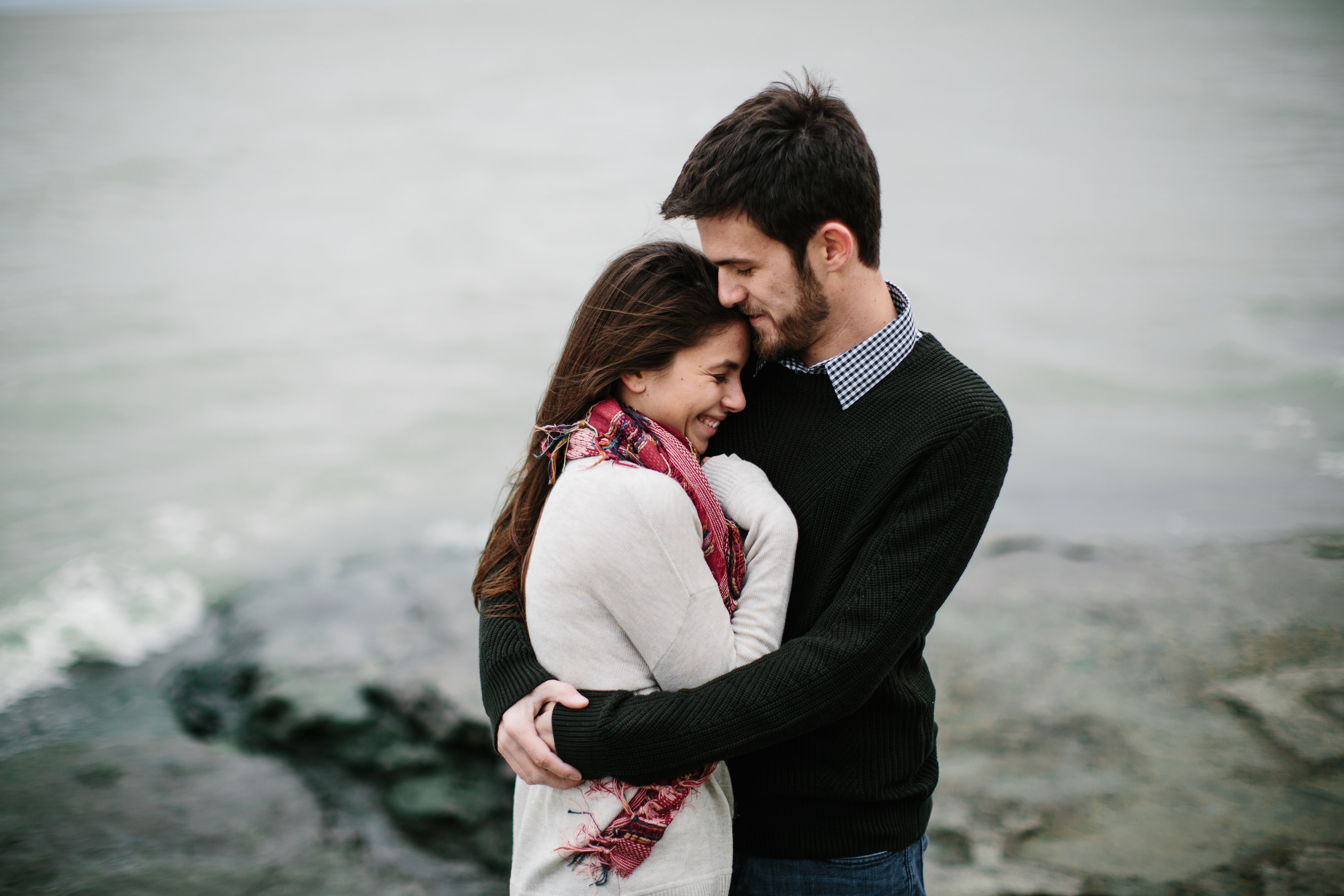 couple hugging by lake