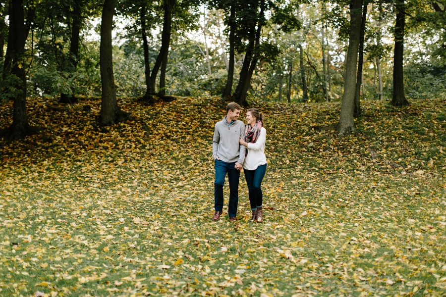 laughing couple surrounded by fall leaves