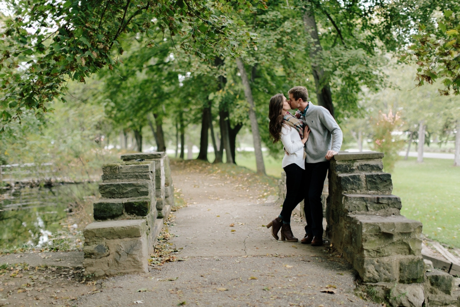 Couple kissing on a bridge in engagement session