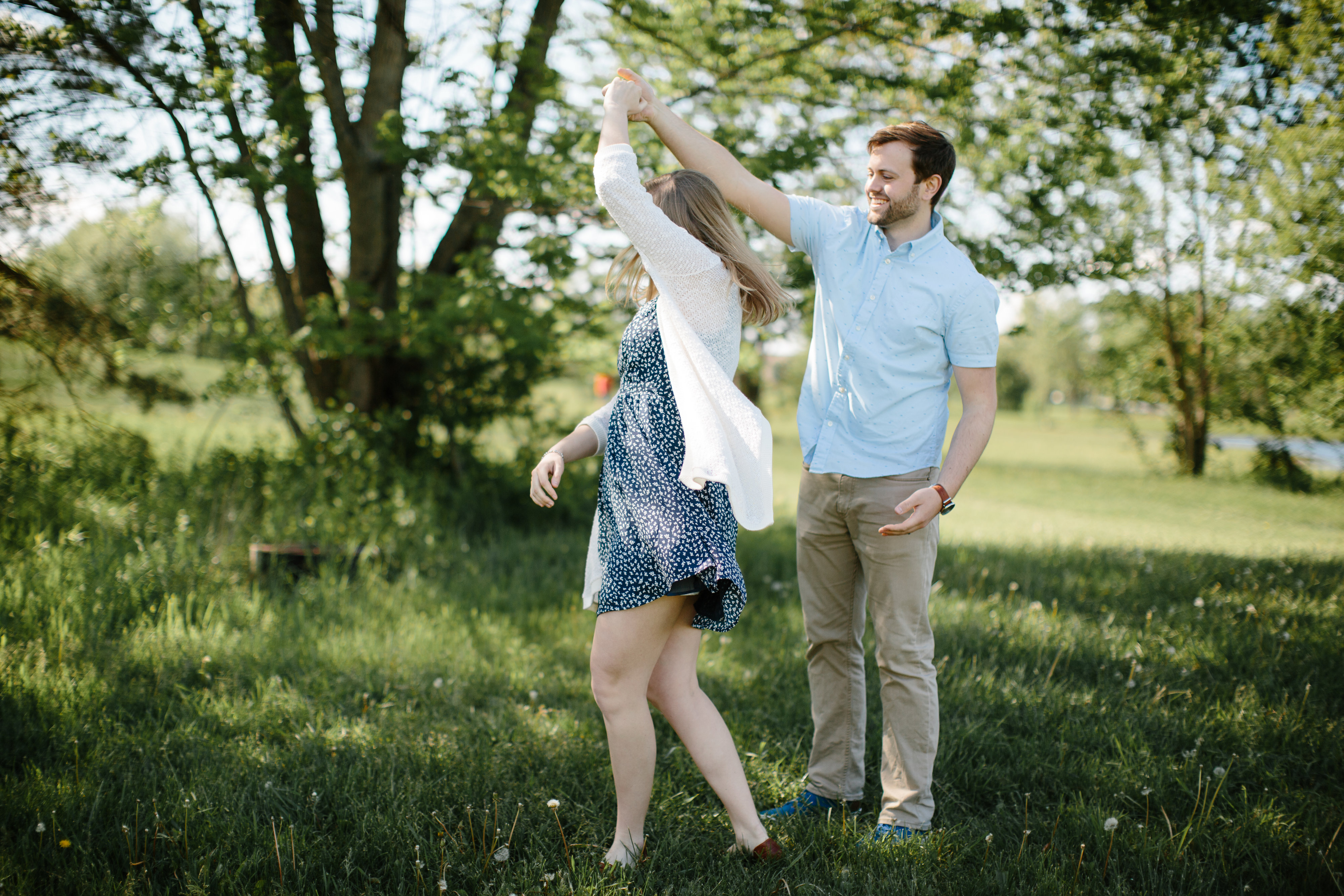 couple dancing under a tree during the spring