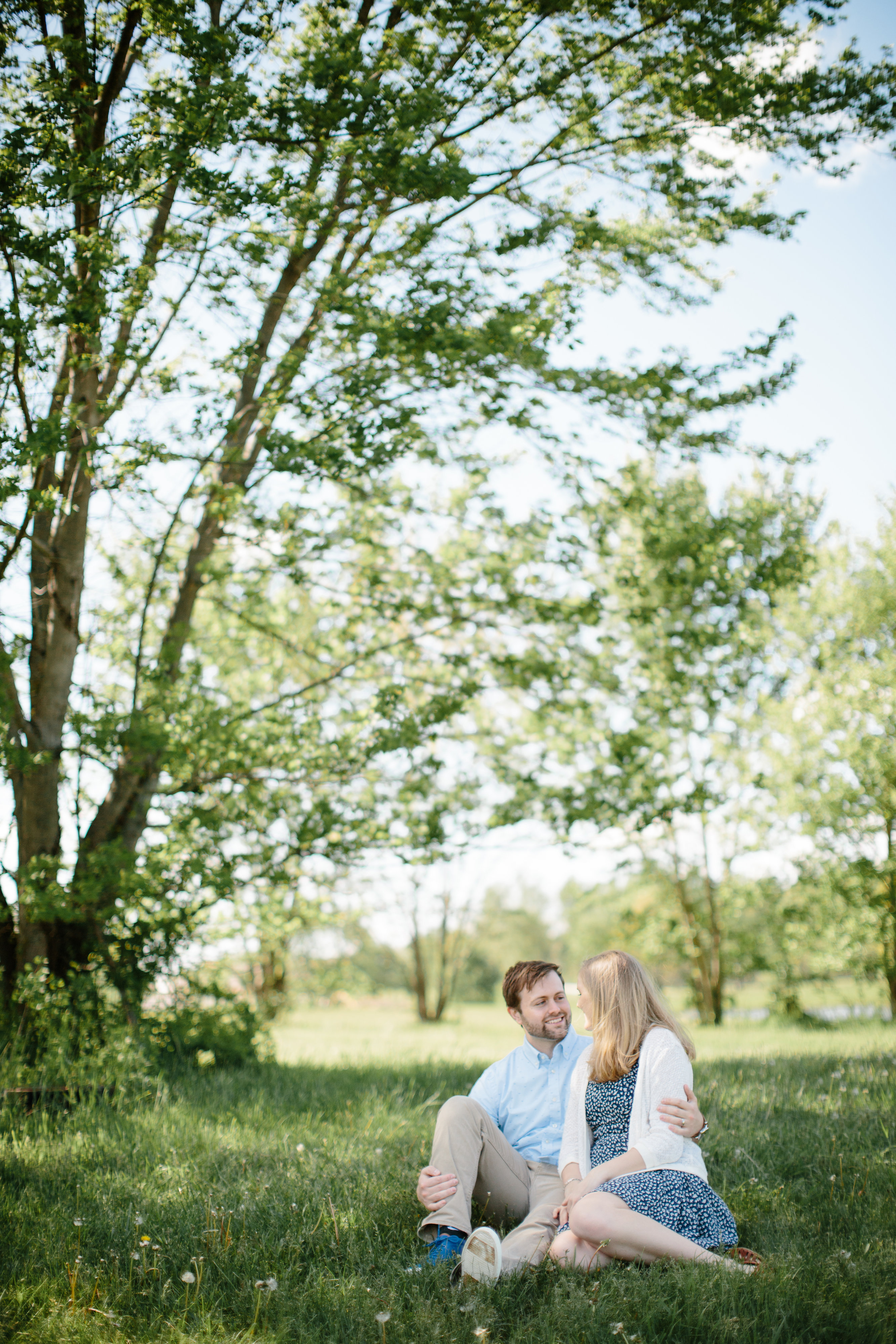 couple snuggling under tree during couple session