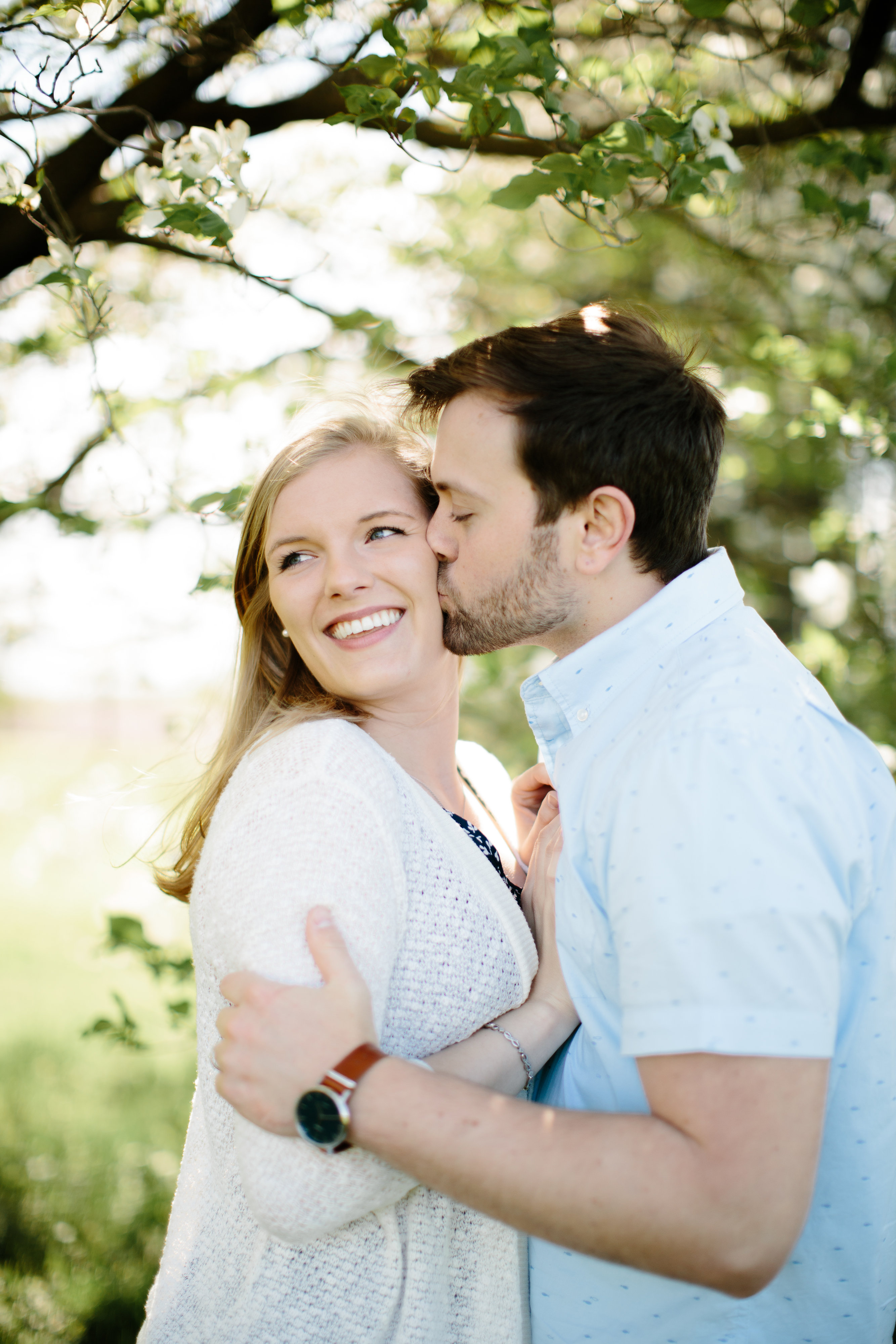 couple snuggling up during spring engagement session