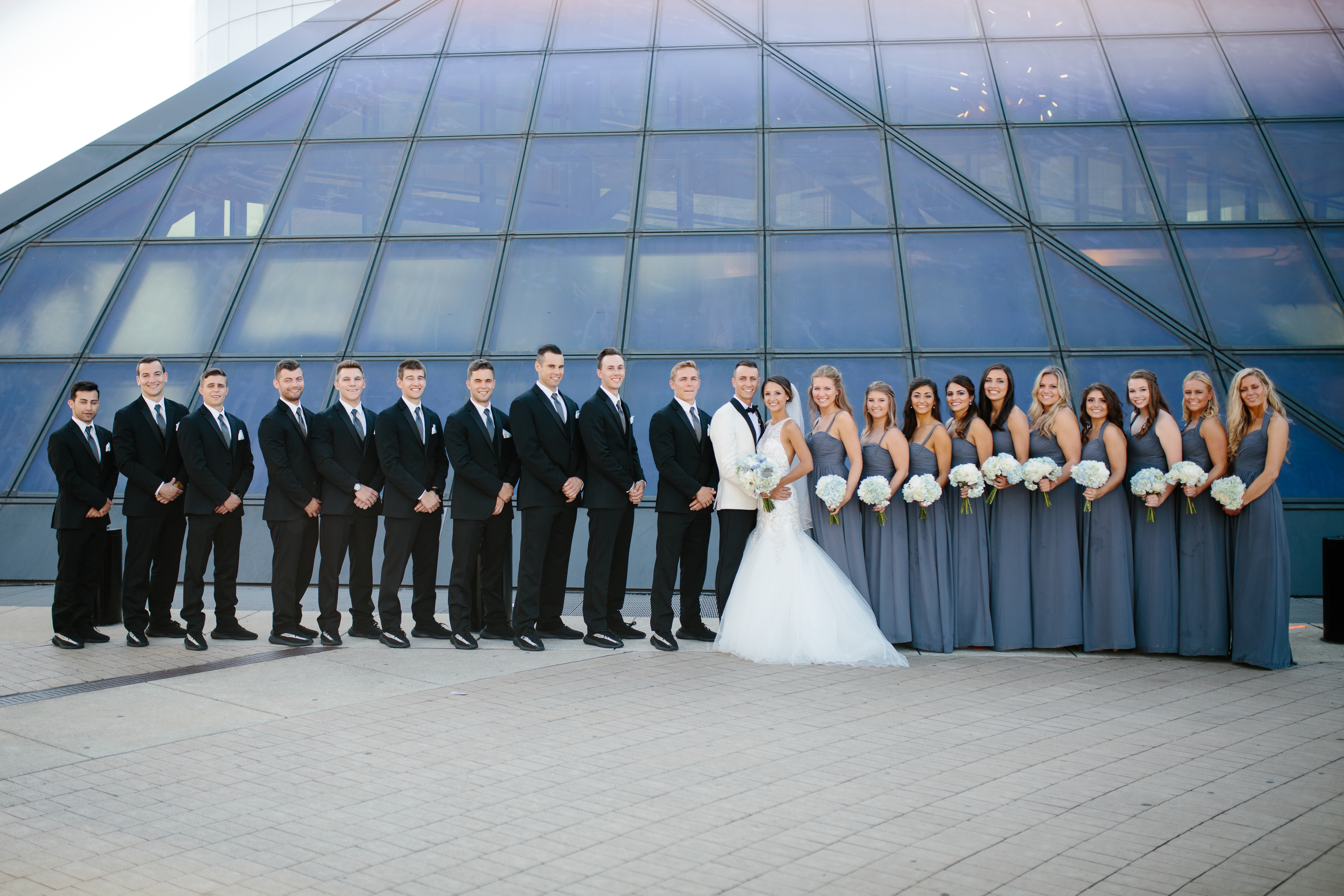 Grey and black wedding party in front of Cleveland Rock Hall