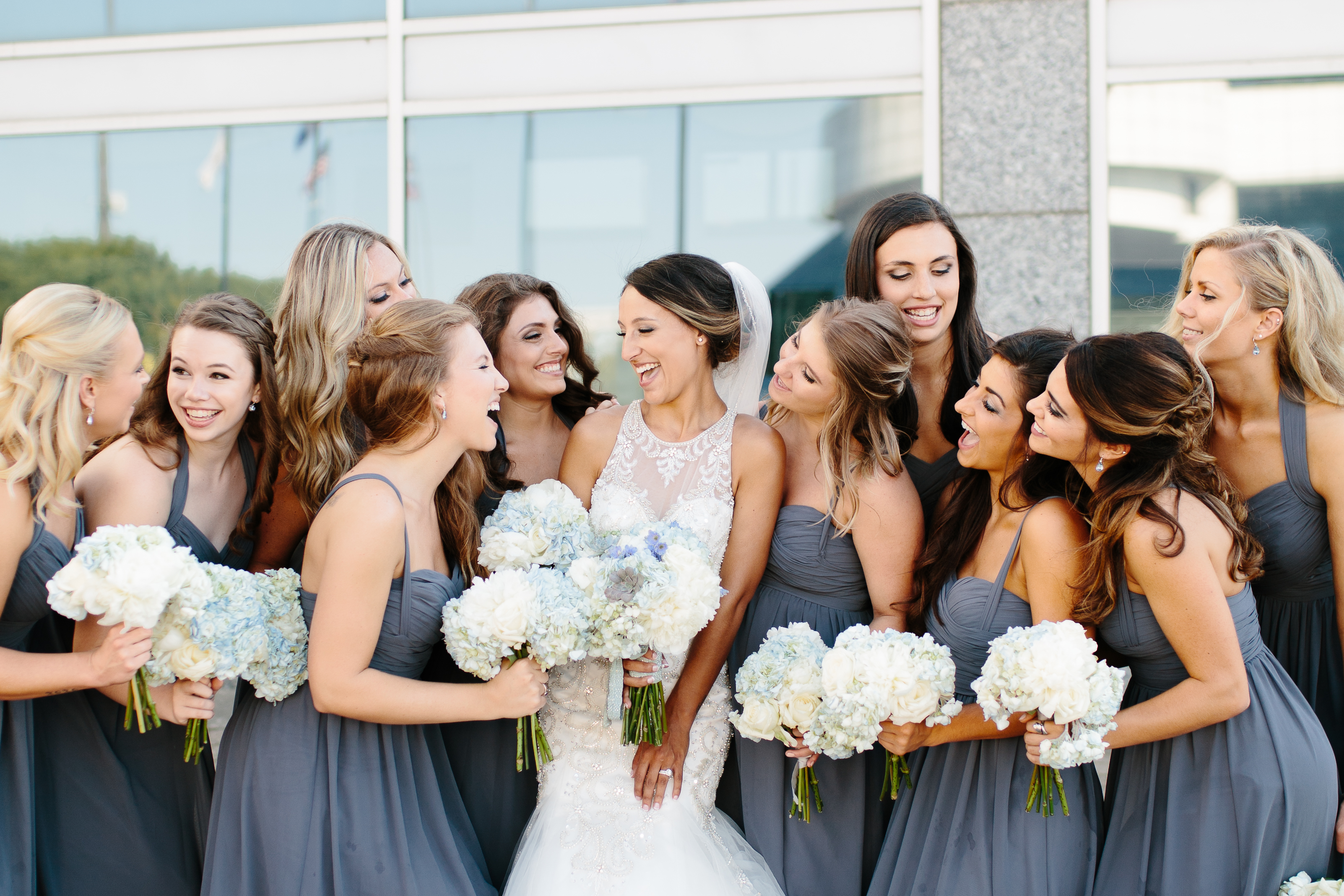 Bridesmaids laughing in Grey and blue dresses