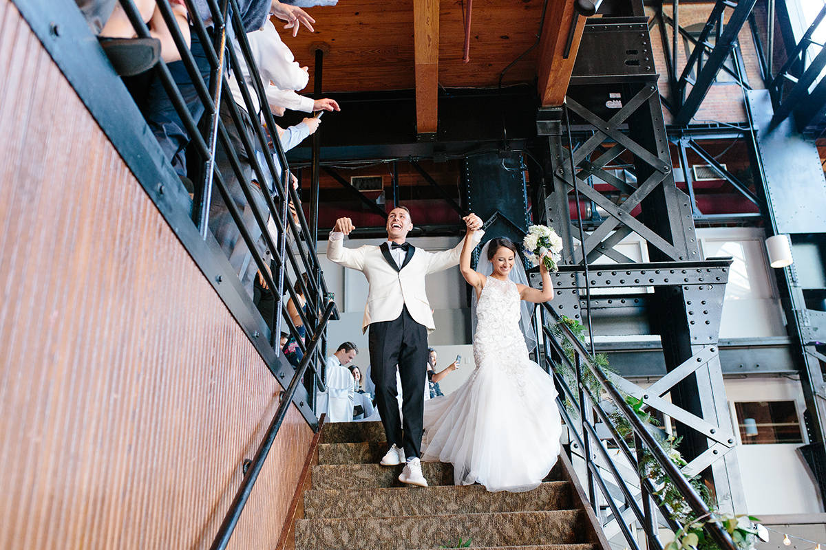 bride and groom excitedly enter windows on the river