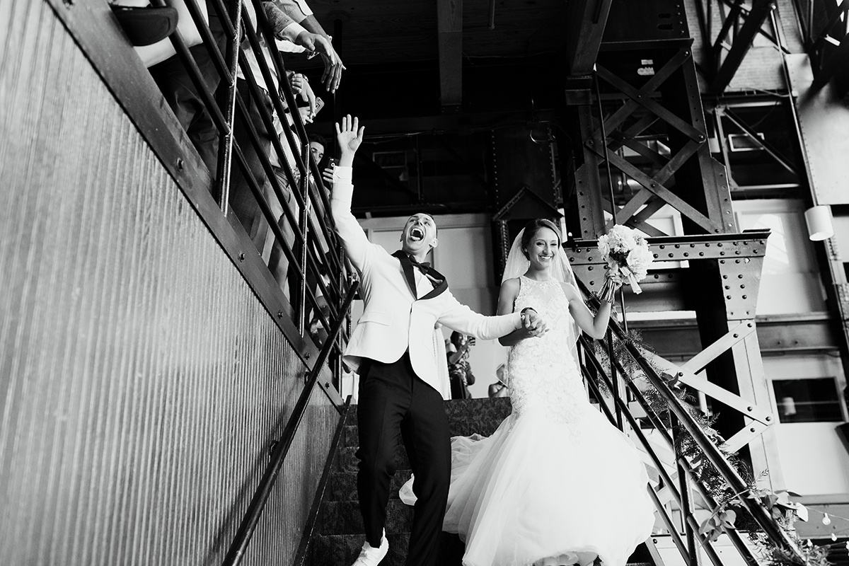 groom gives high five at wedding reception