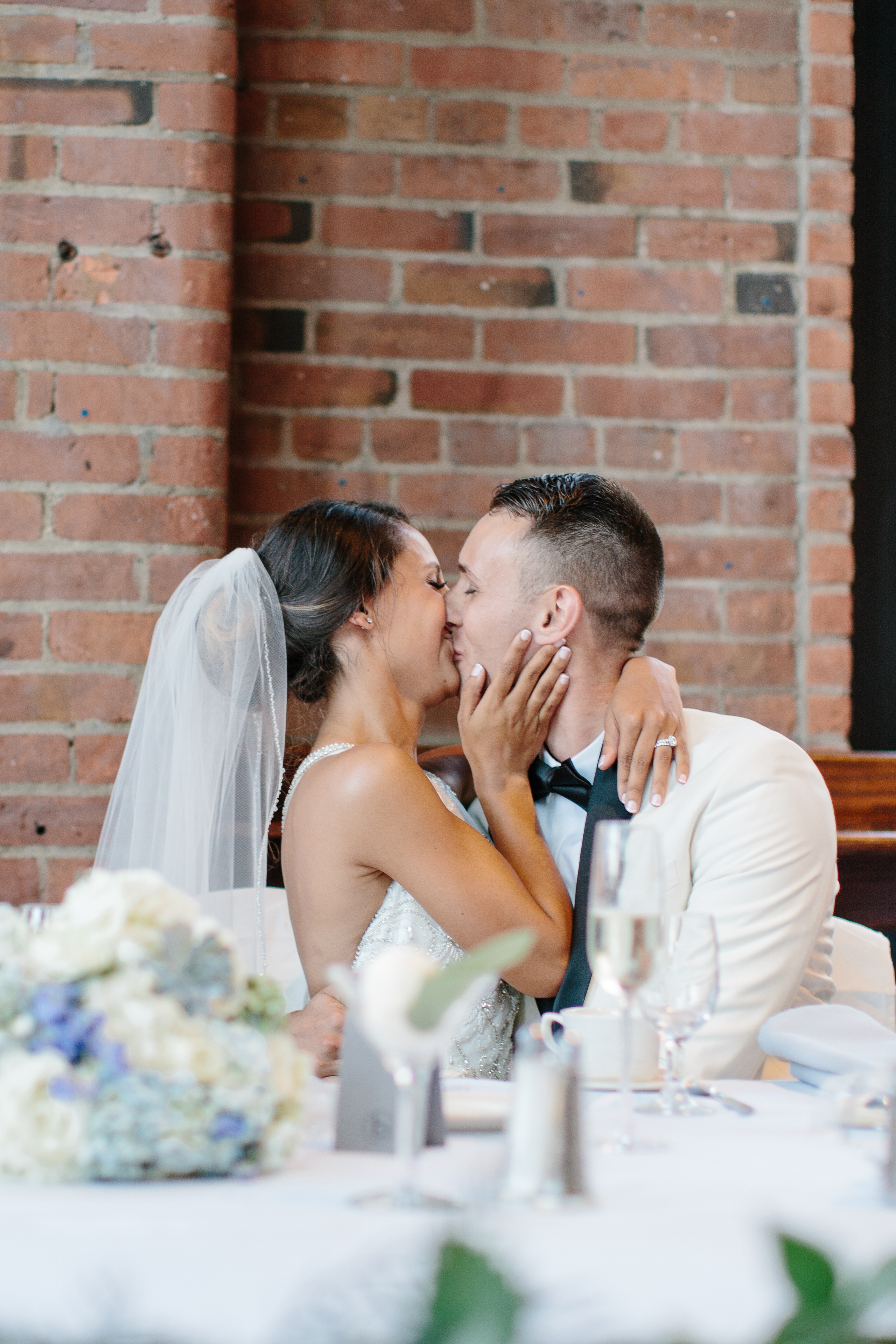 Bride and groom kiss during reception