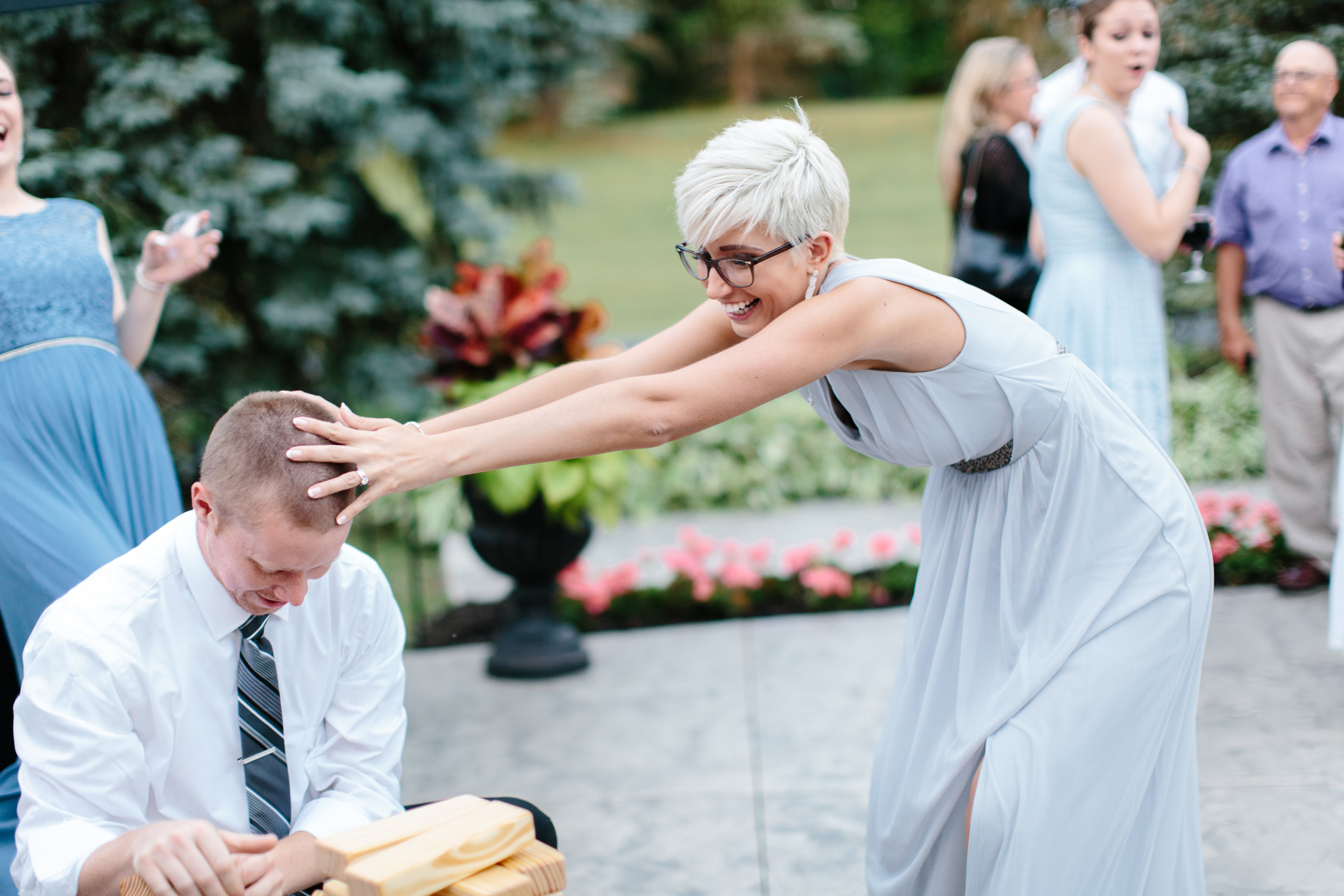 bridesmaid plays jenga at wedding reception