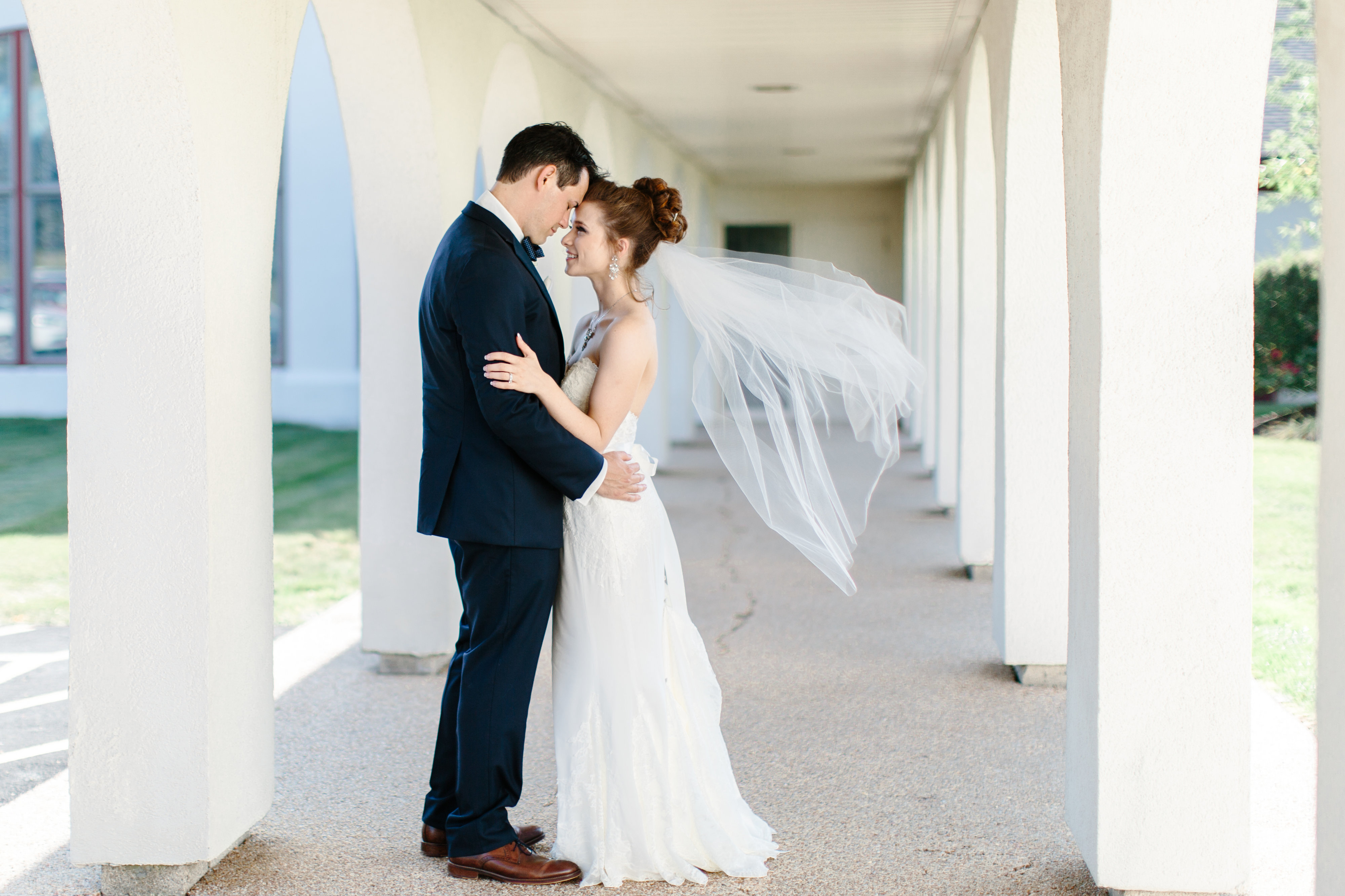 veil blows in the wind at romantic navy and pink wedding