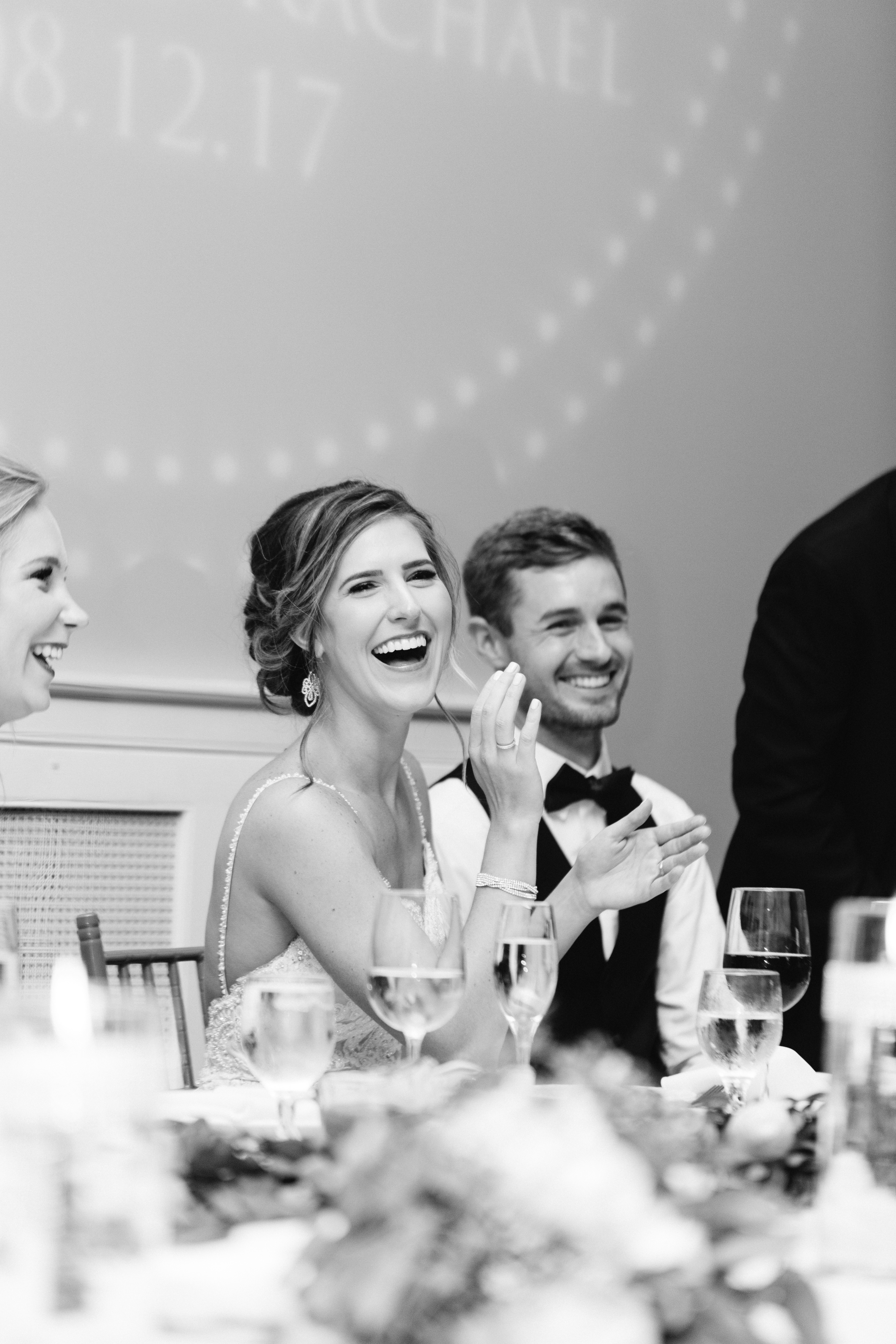 bride and groom laugh during toasts at the Historic Onesto Loft