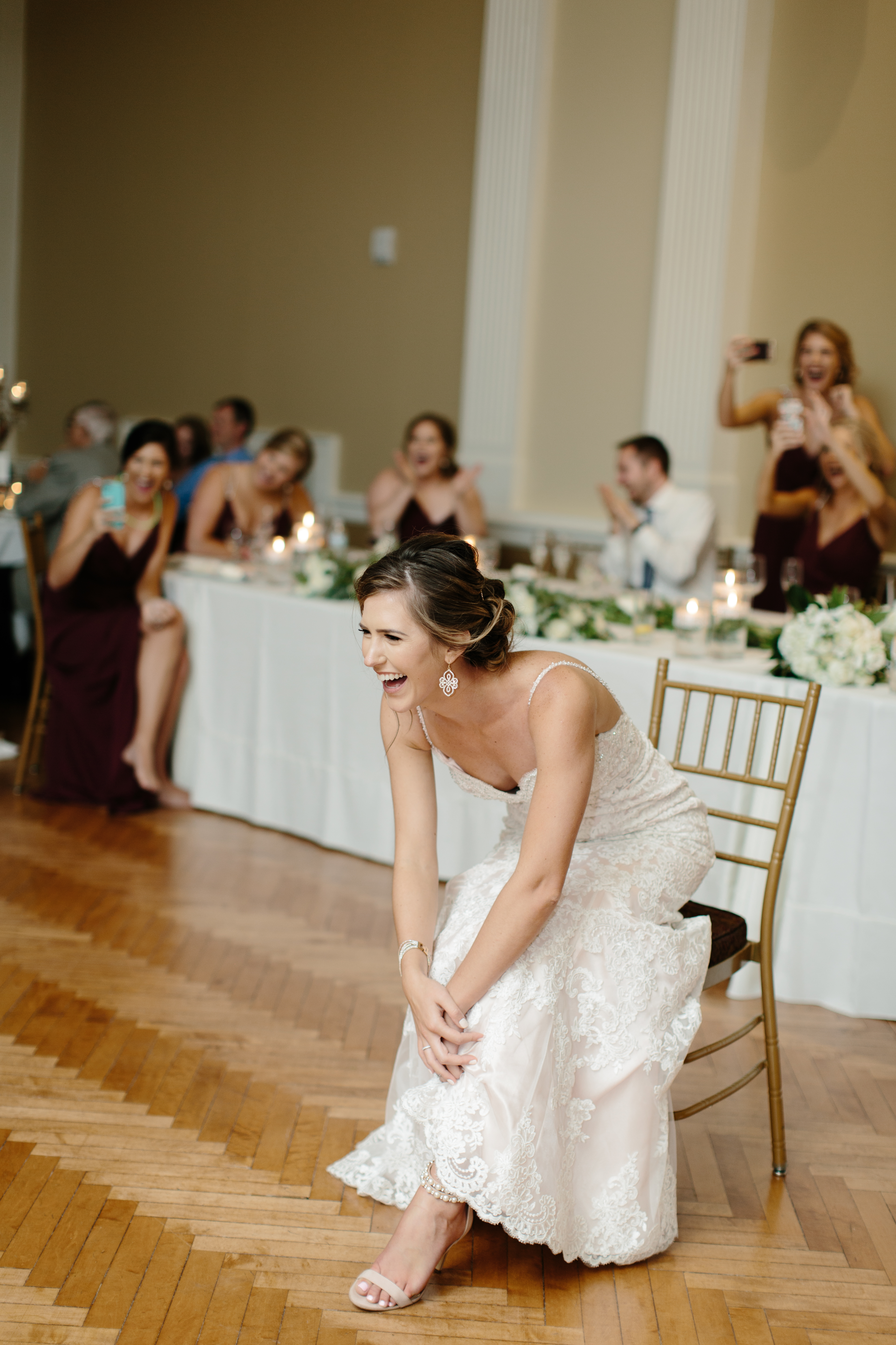 bride laughs while groom dances at historic onesto loft