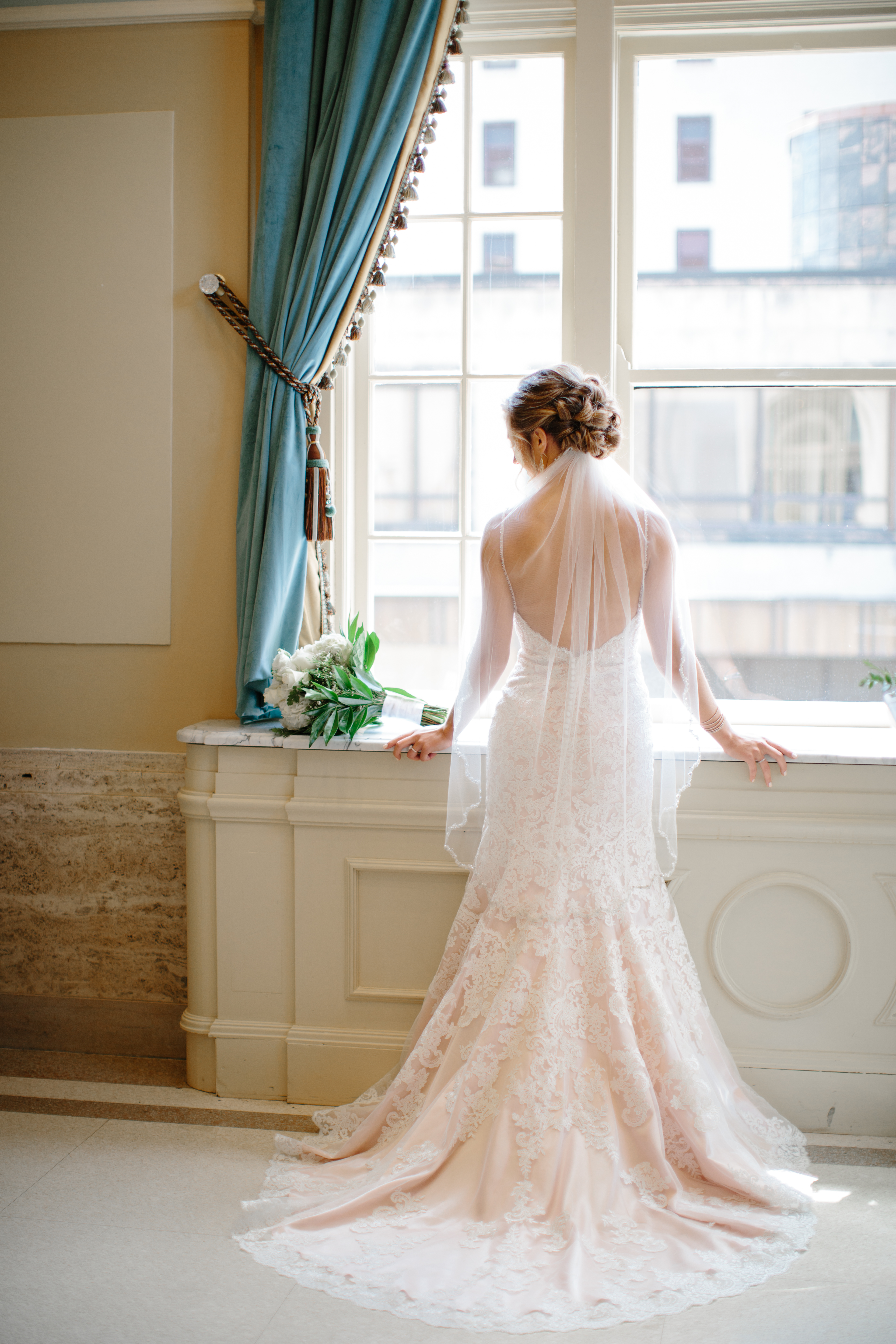 Bride looking out window in Downtown Canton Historic Onesto