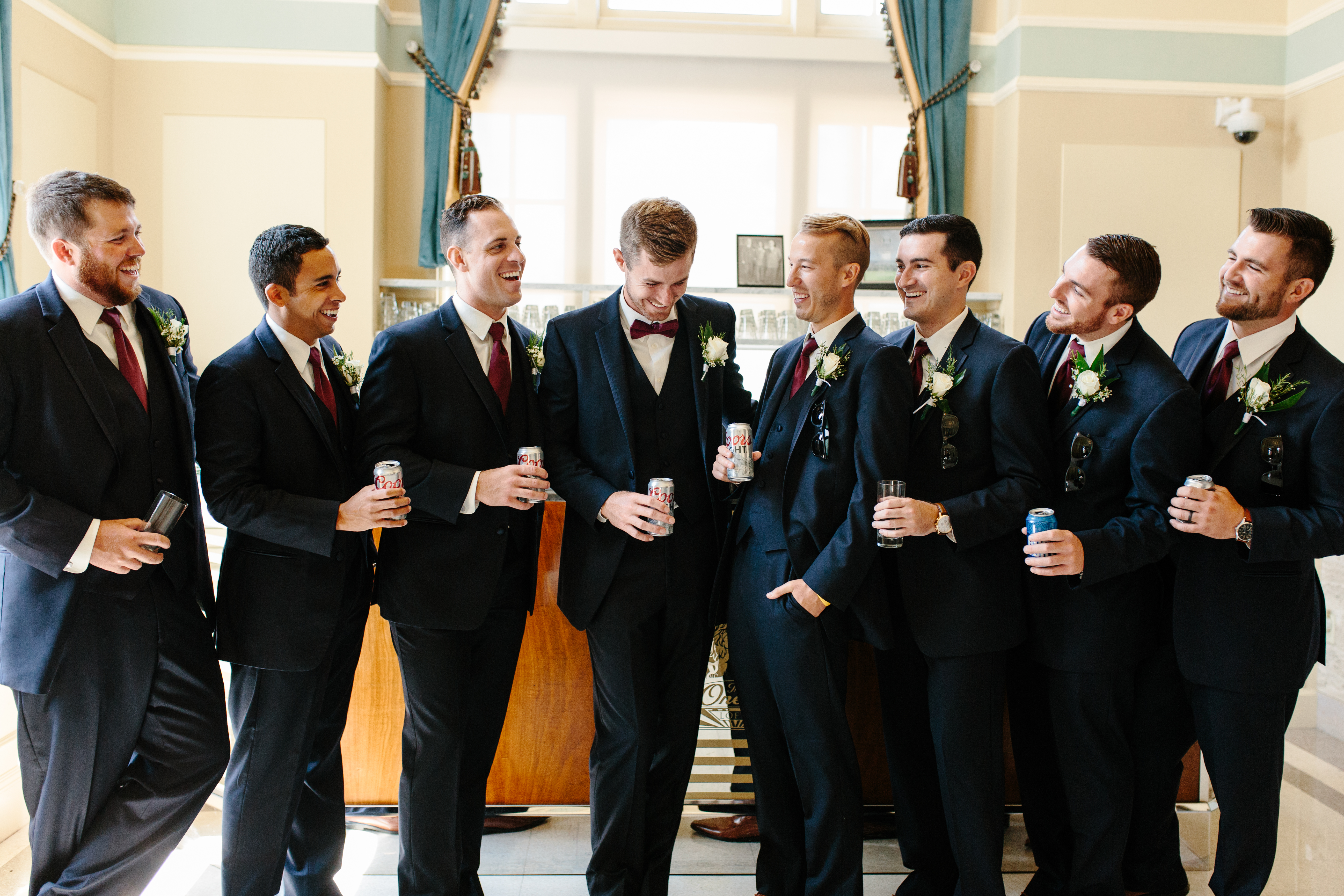 groom and groomsmen share a drink before wedding