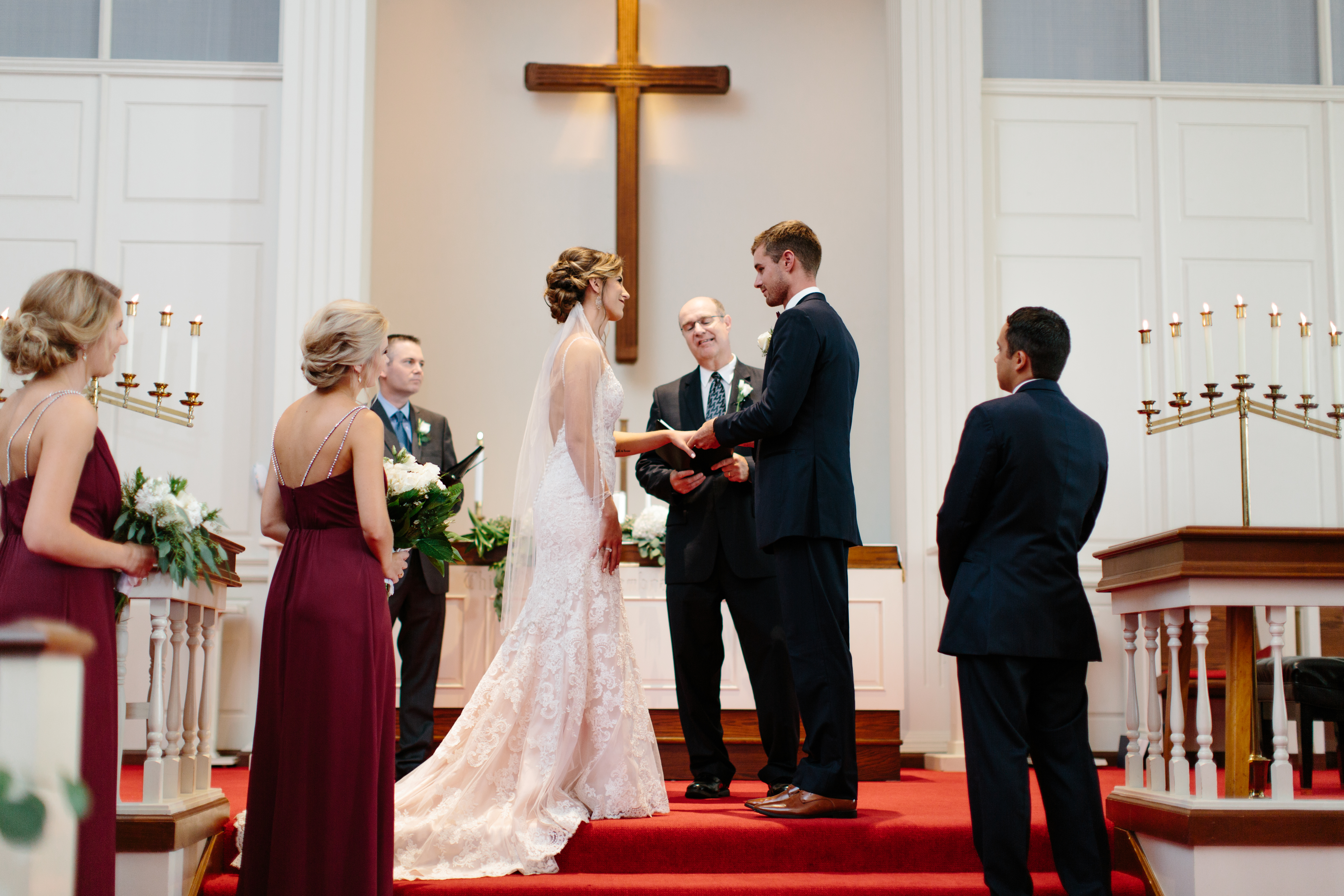 bride and groom exchange rings in North Canton Church