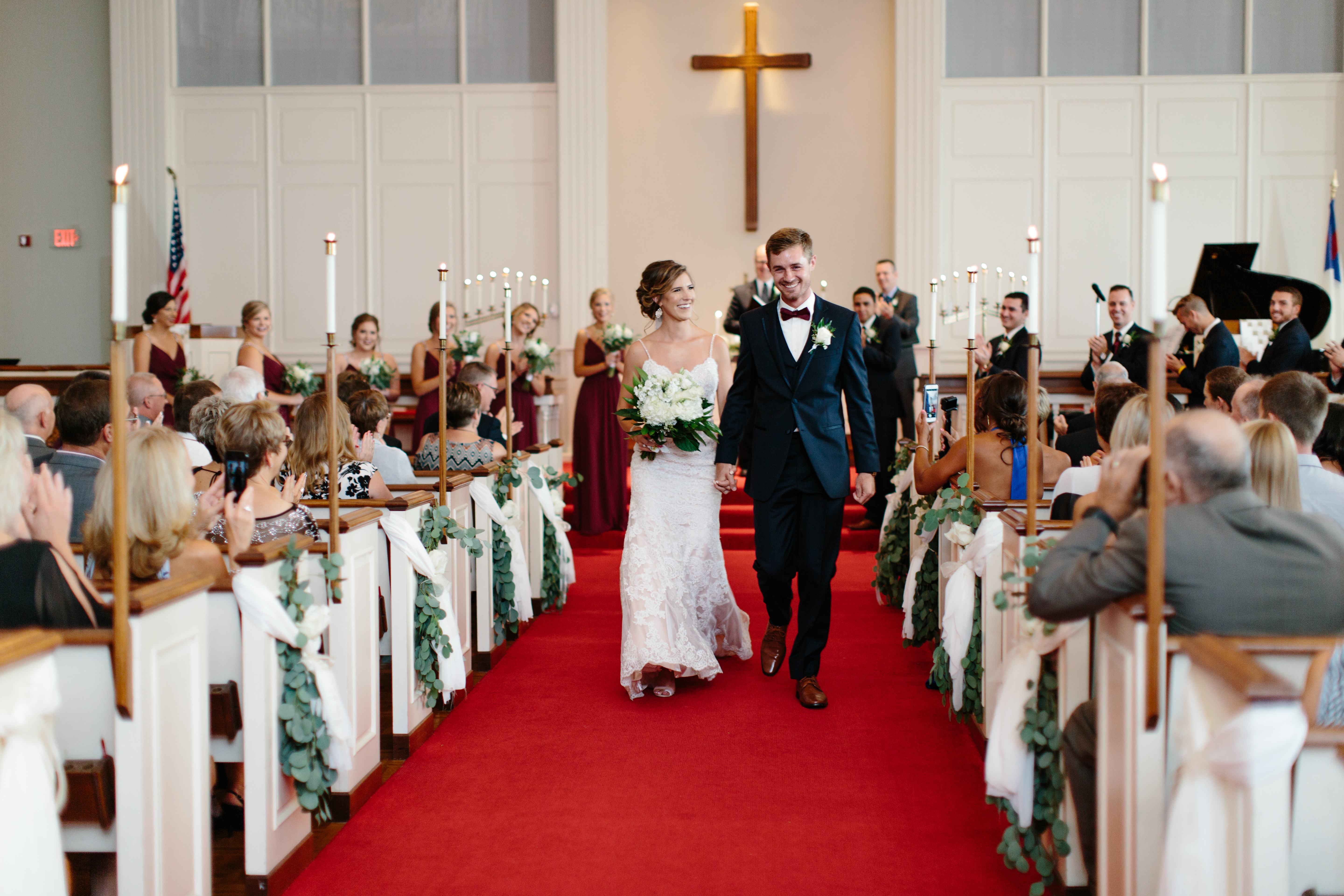 Couple walk down aisle after wedding ceremony
