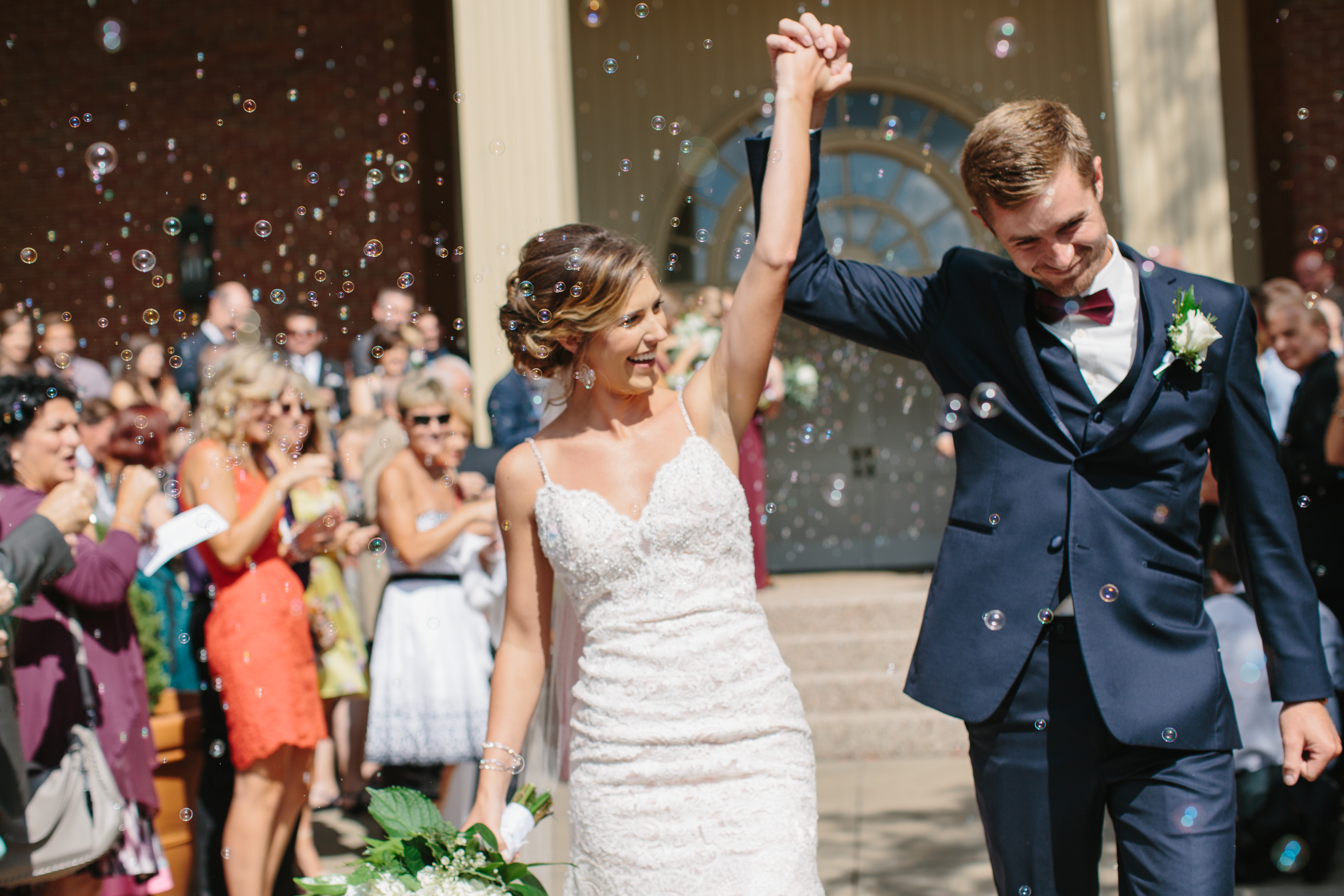 Couple walks through bubbles at wedding ceremony