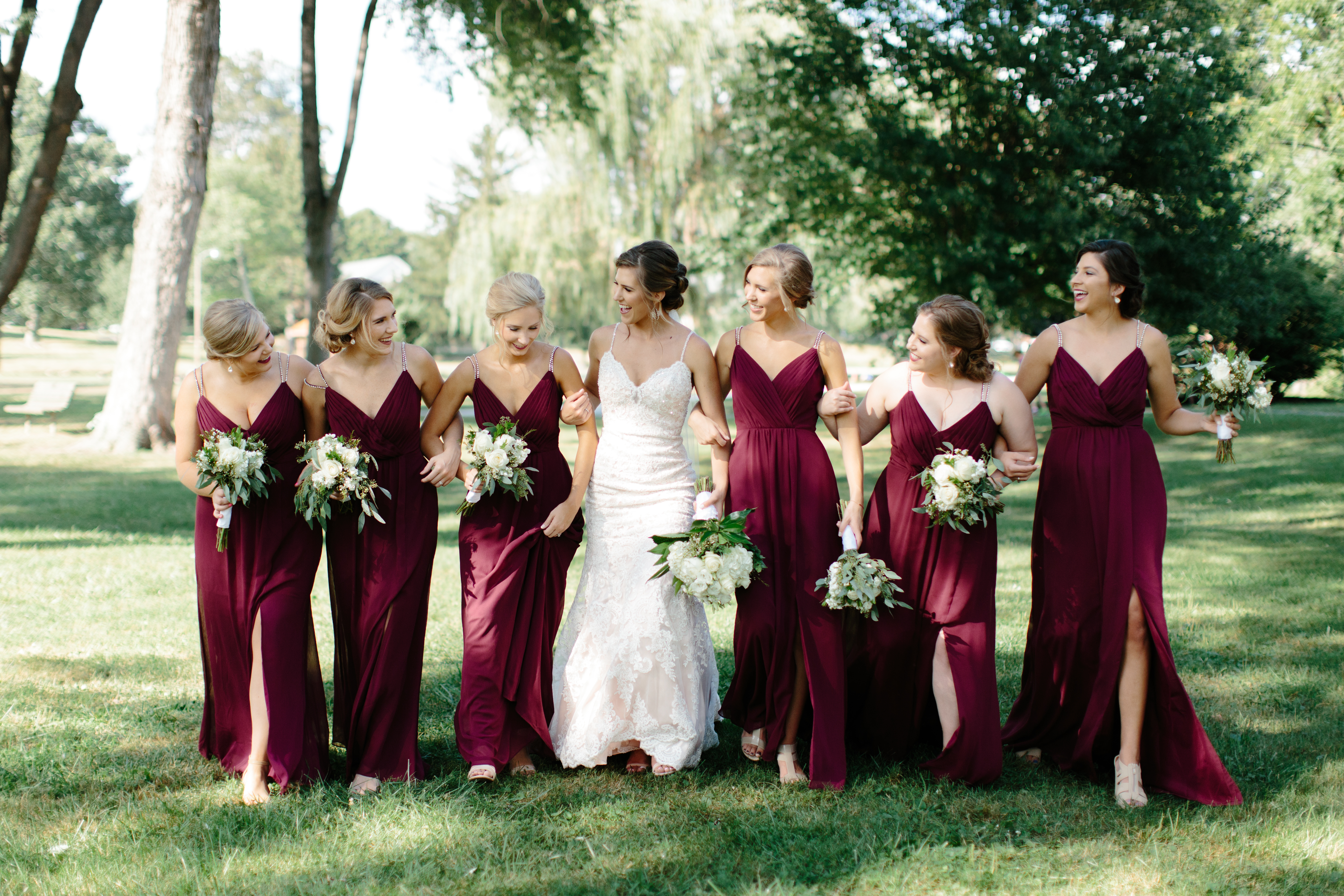 bridesmaids in maroon dress walk together