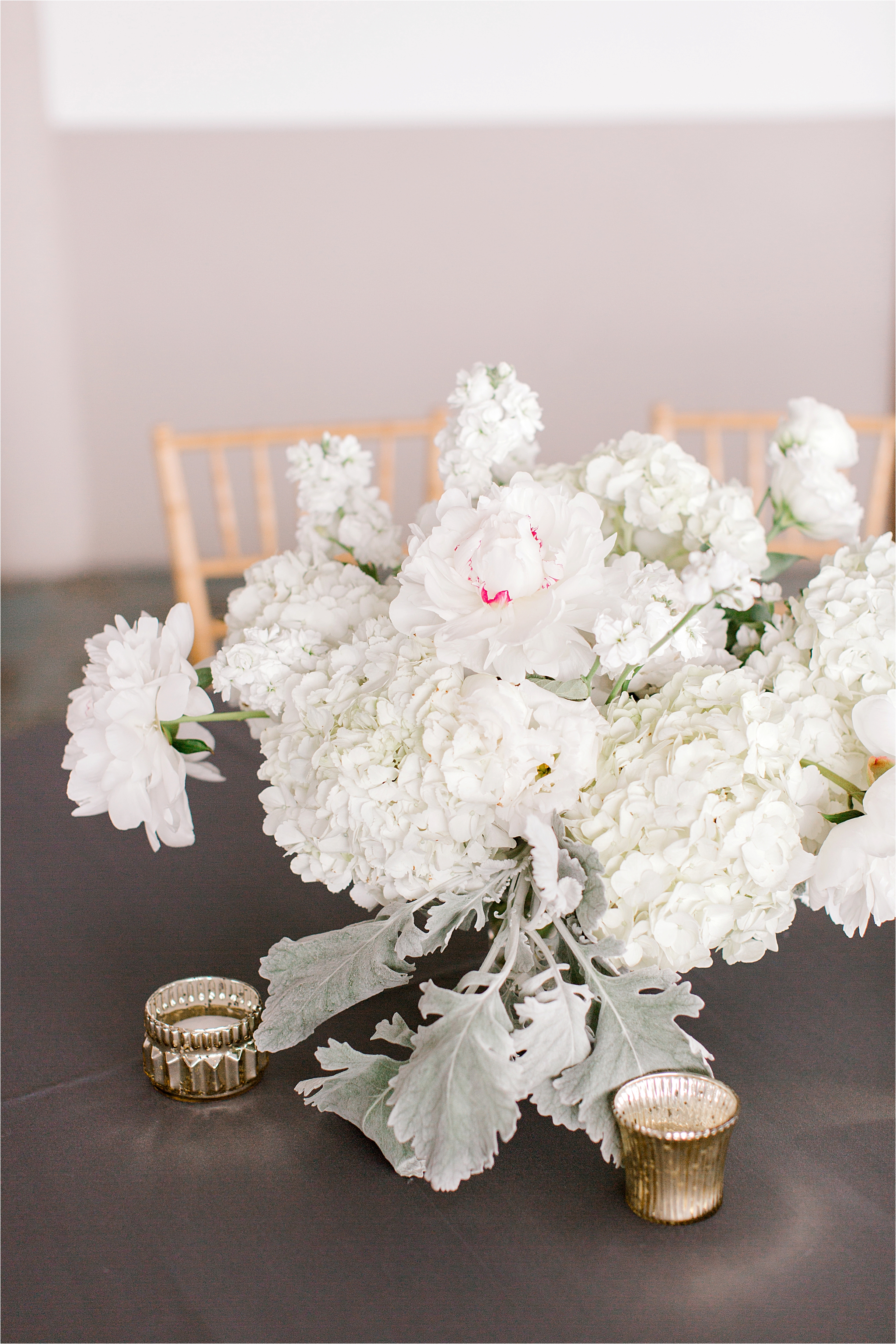 white and greenery wedding centerpieces by we are wildflowers