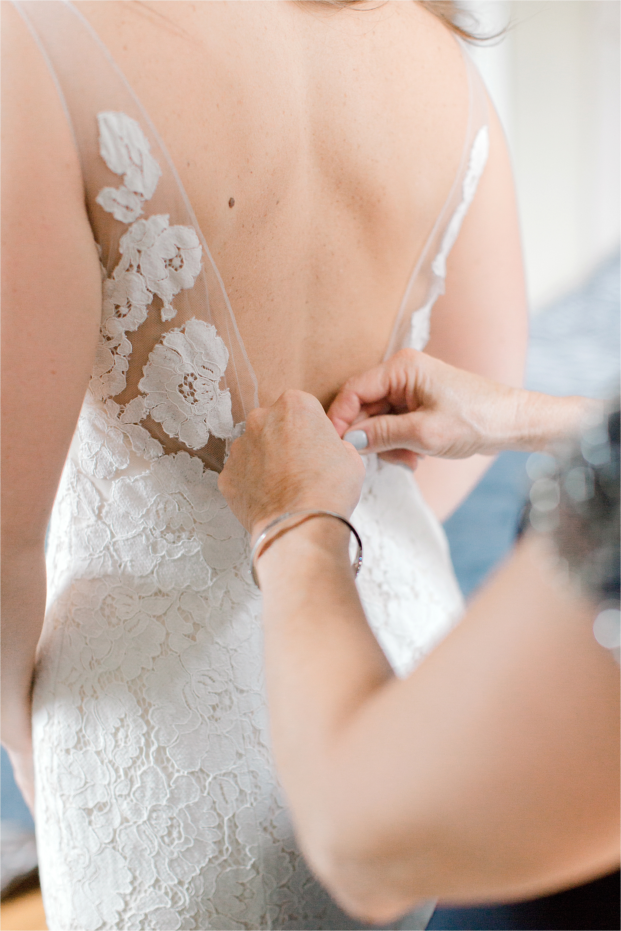 lace wedding dress being buttoned 