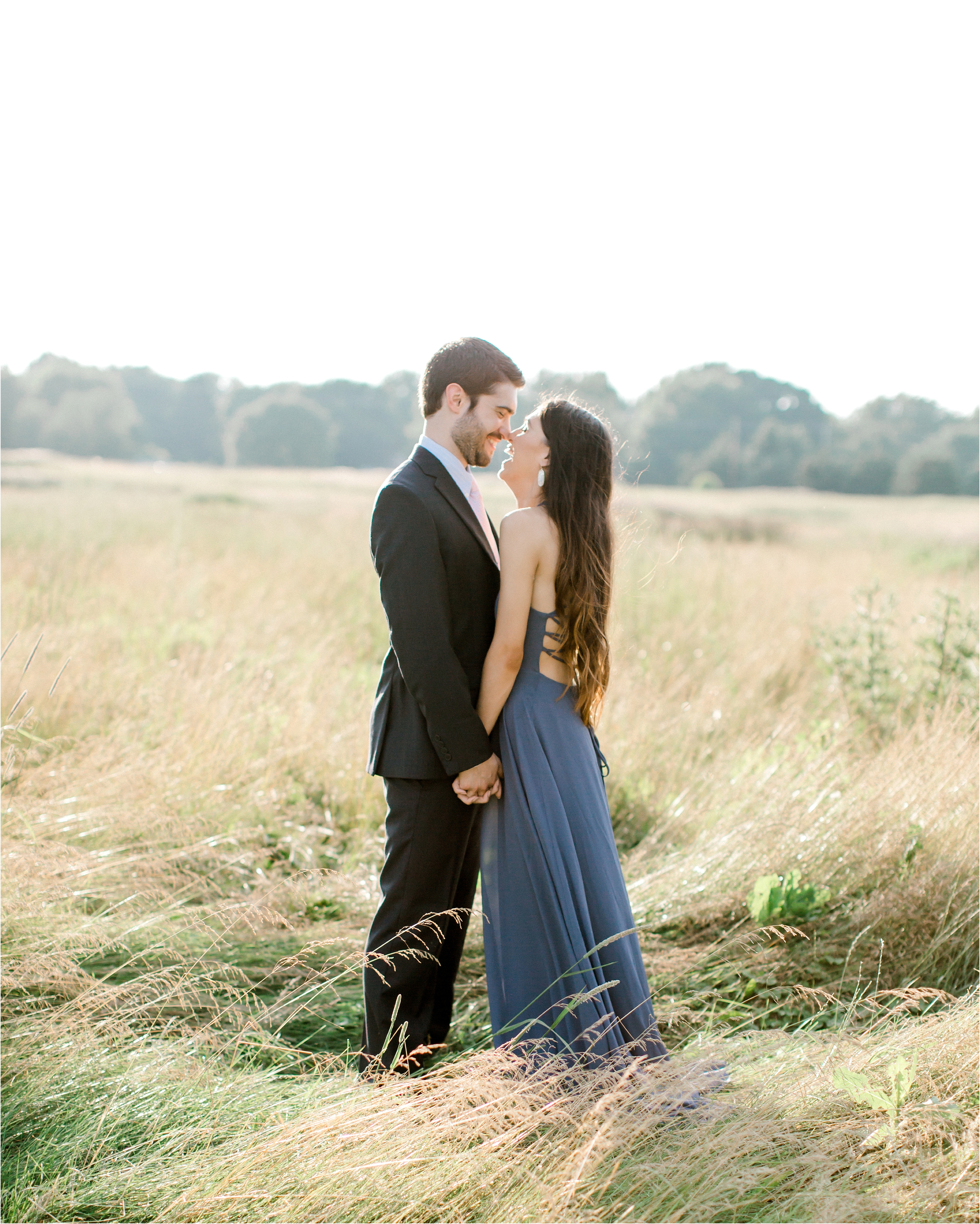 romantic field engagement session in blue dress