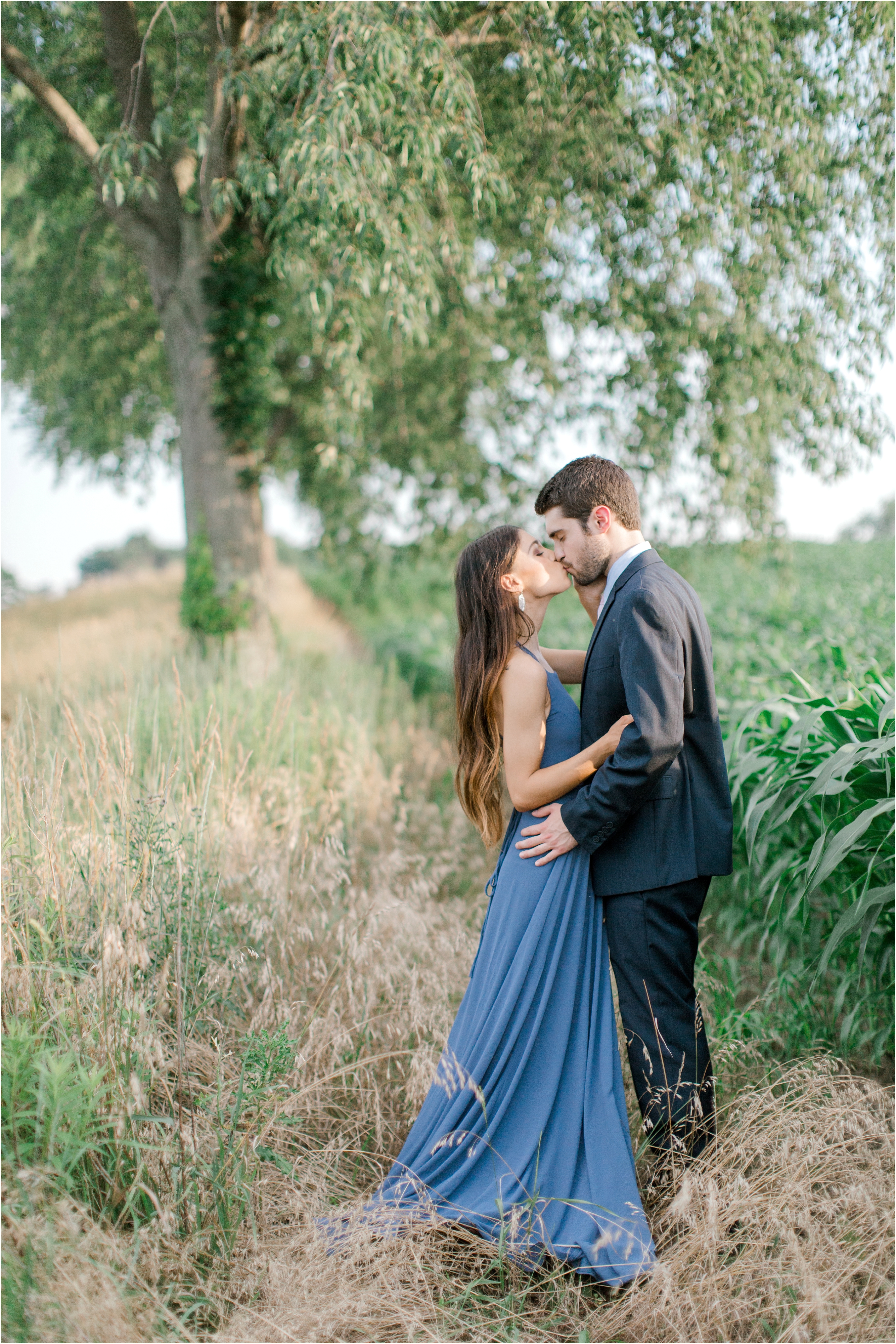 blue dress engagement session in romantic whimsical field 