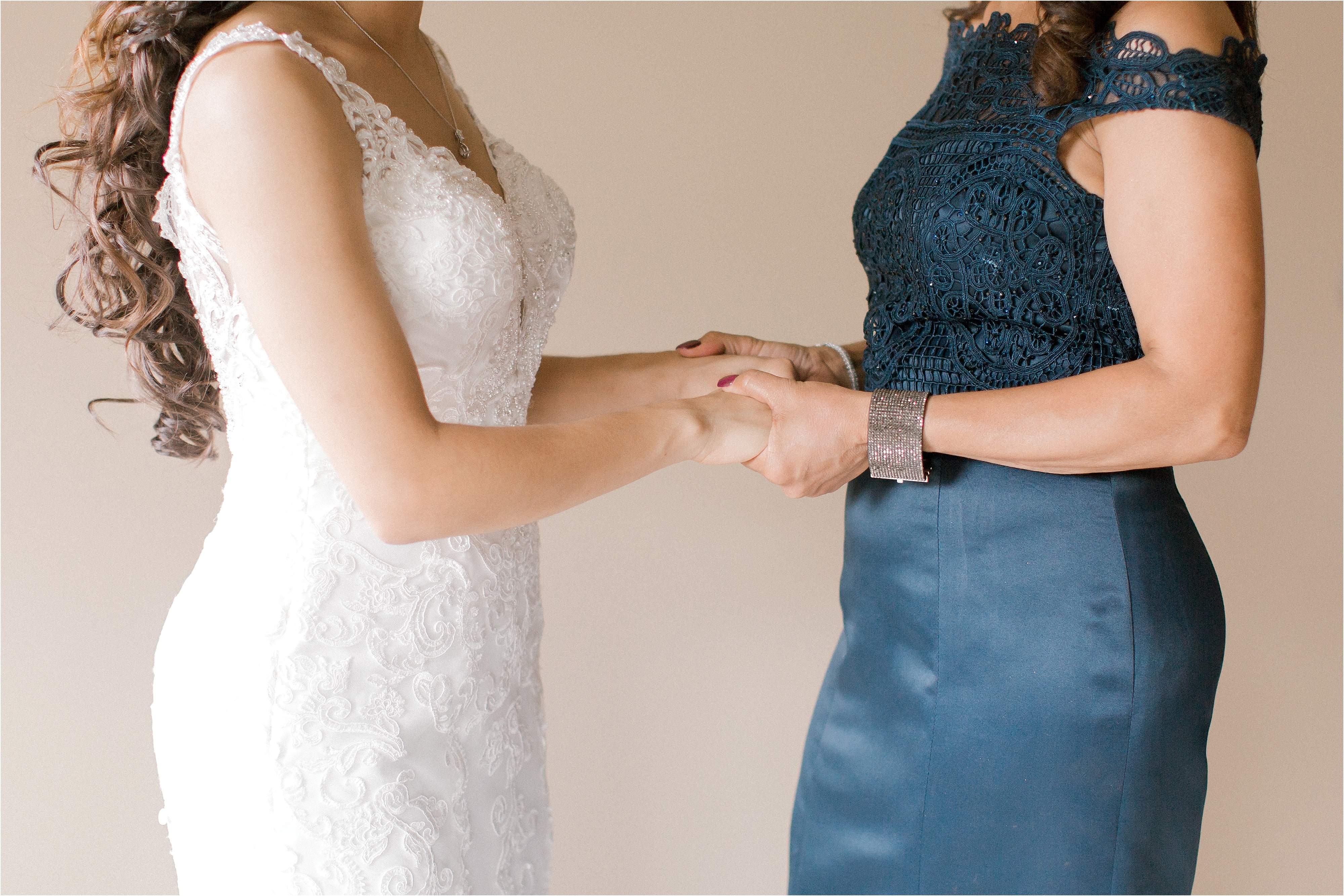 mother daughter holding hands at wedding 