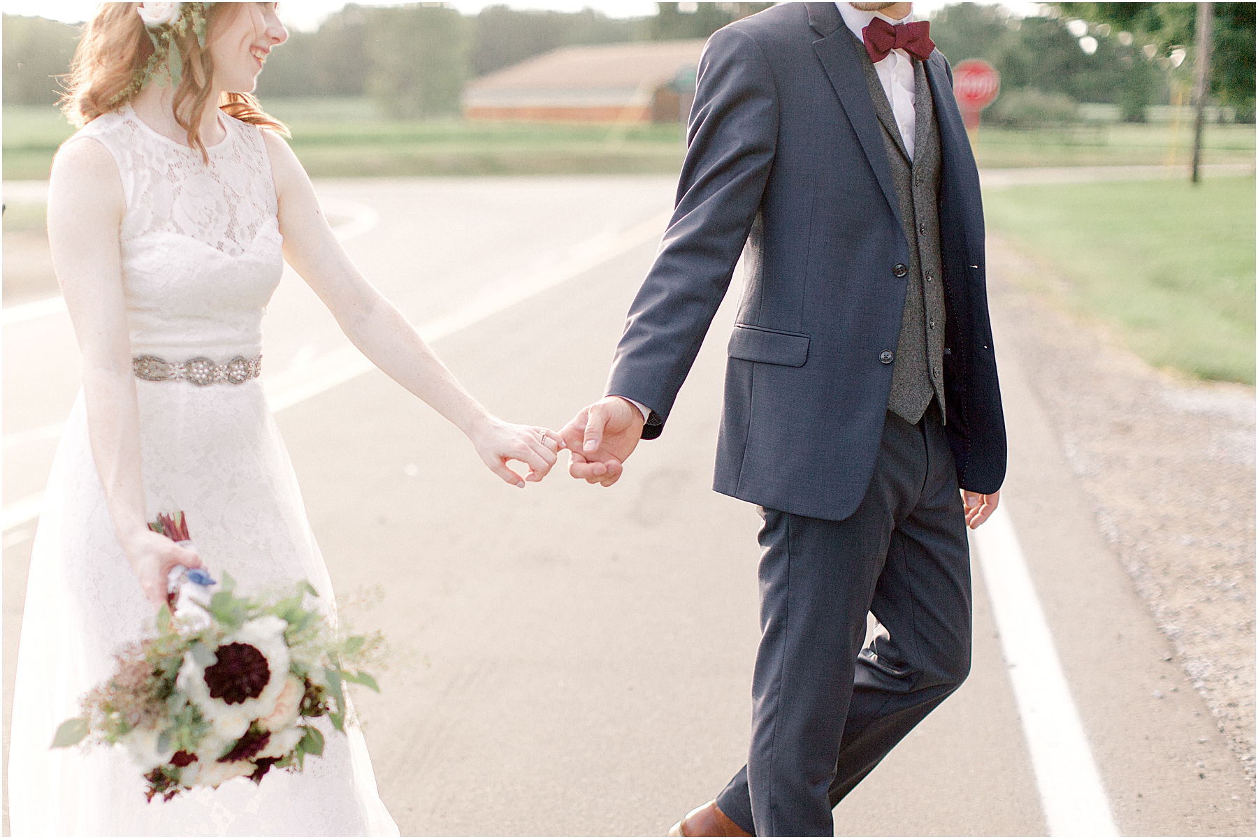 holding hands at whimsical summer camp wedding