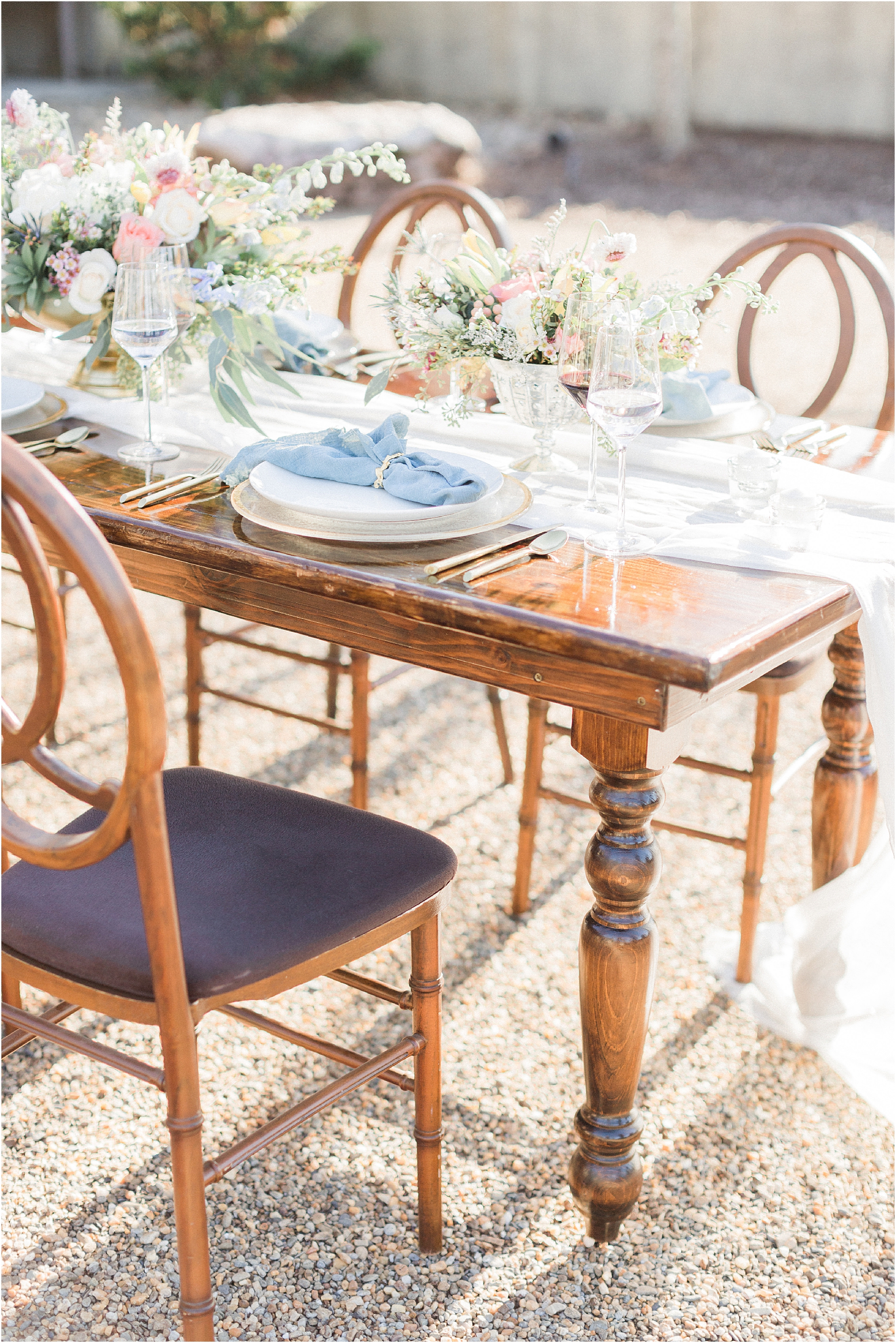 pink and blue table setting on farm table 