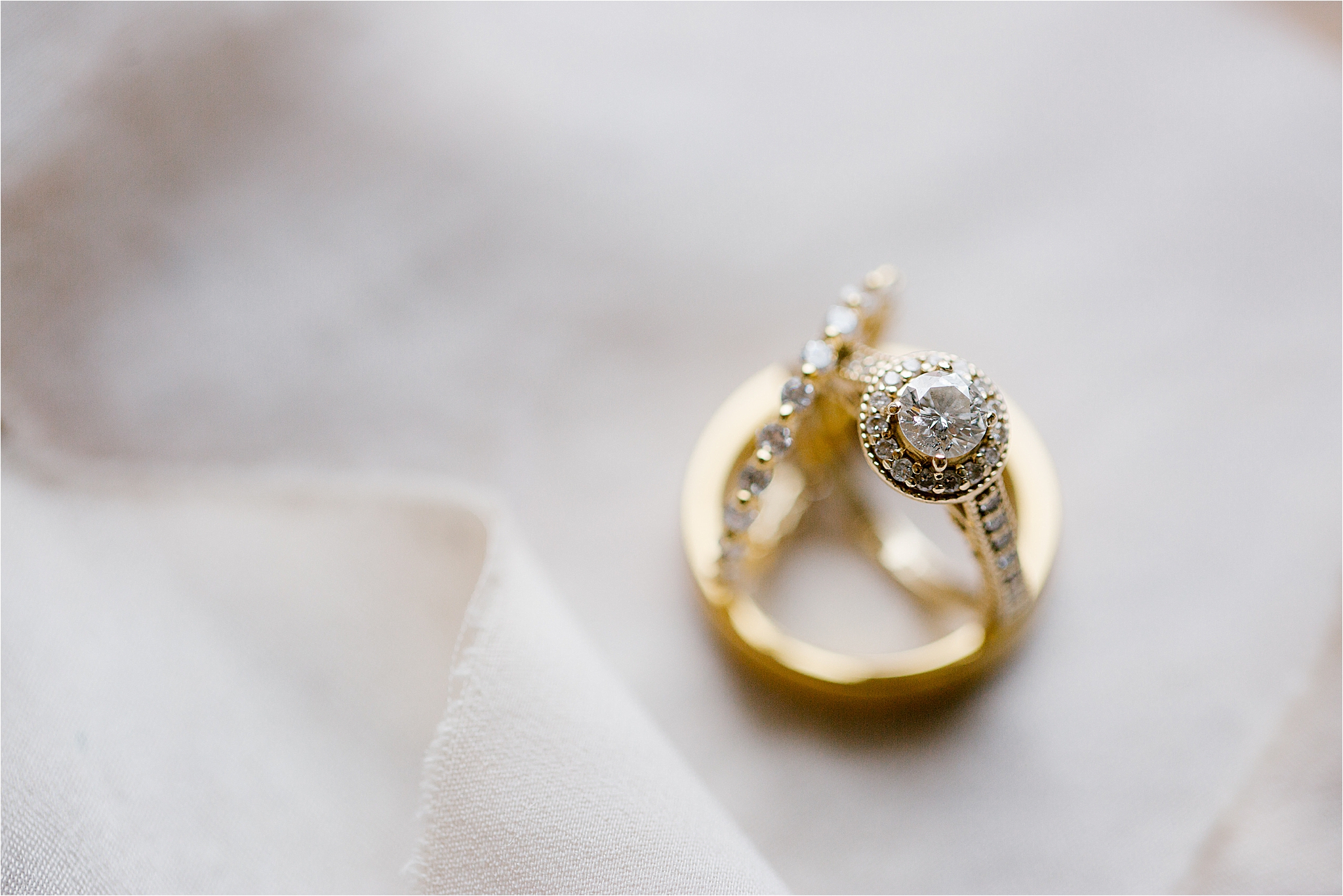 Gold round diamond engagement ring with diamond surround