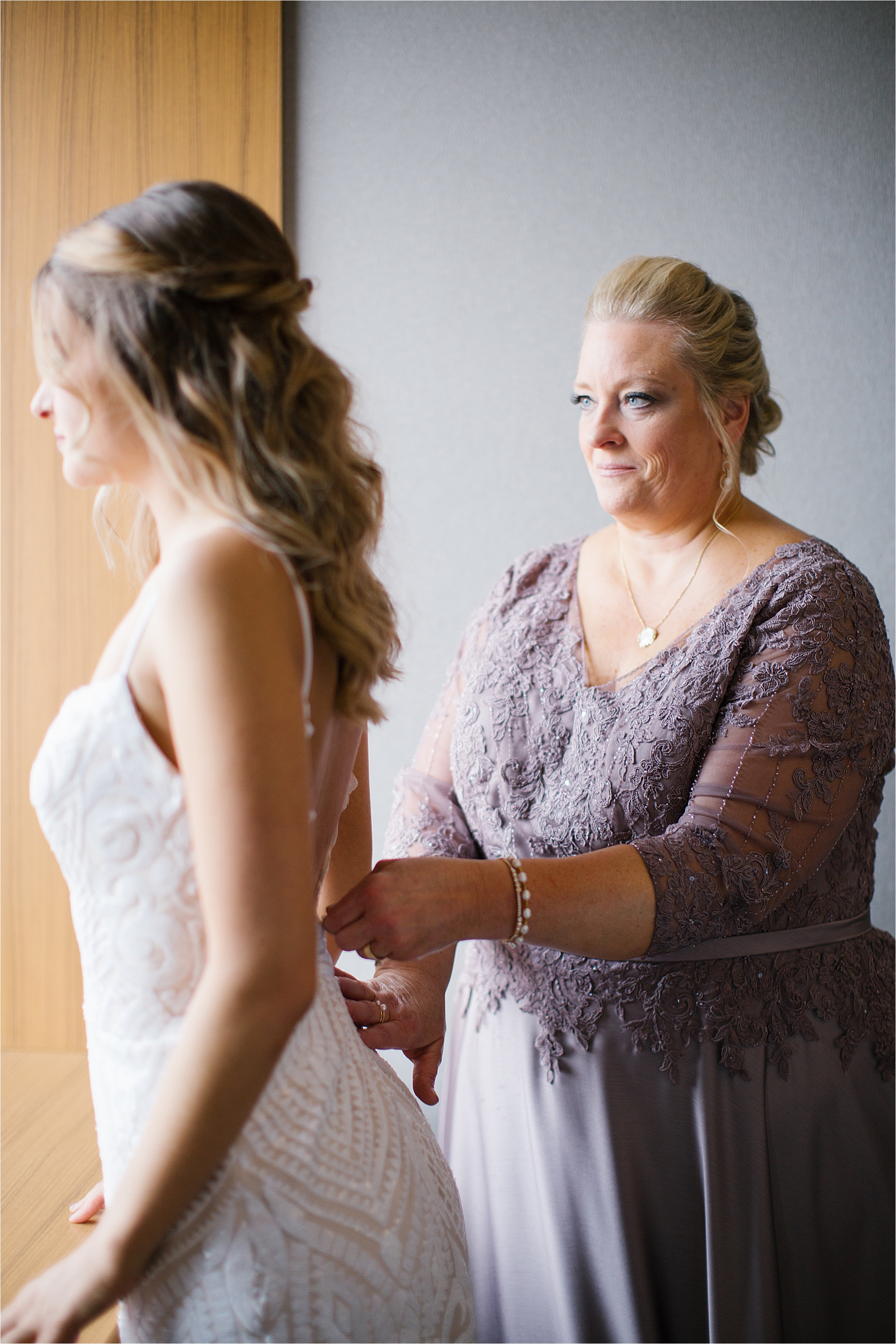 Mom helping bride into dress at Cleveland Wedding