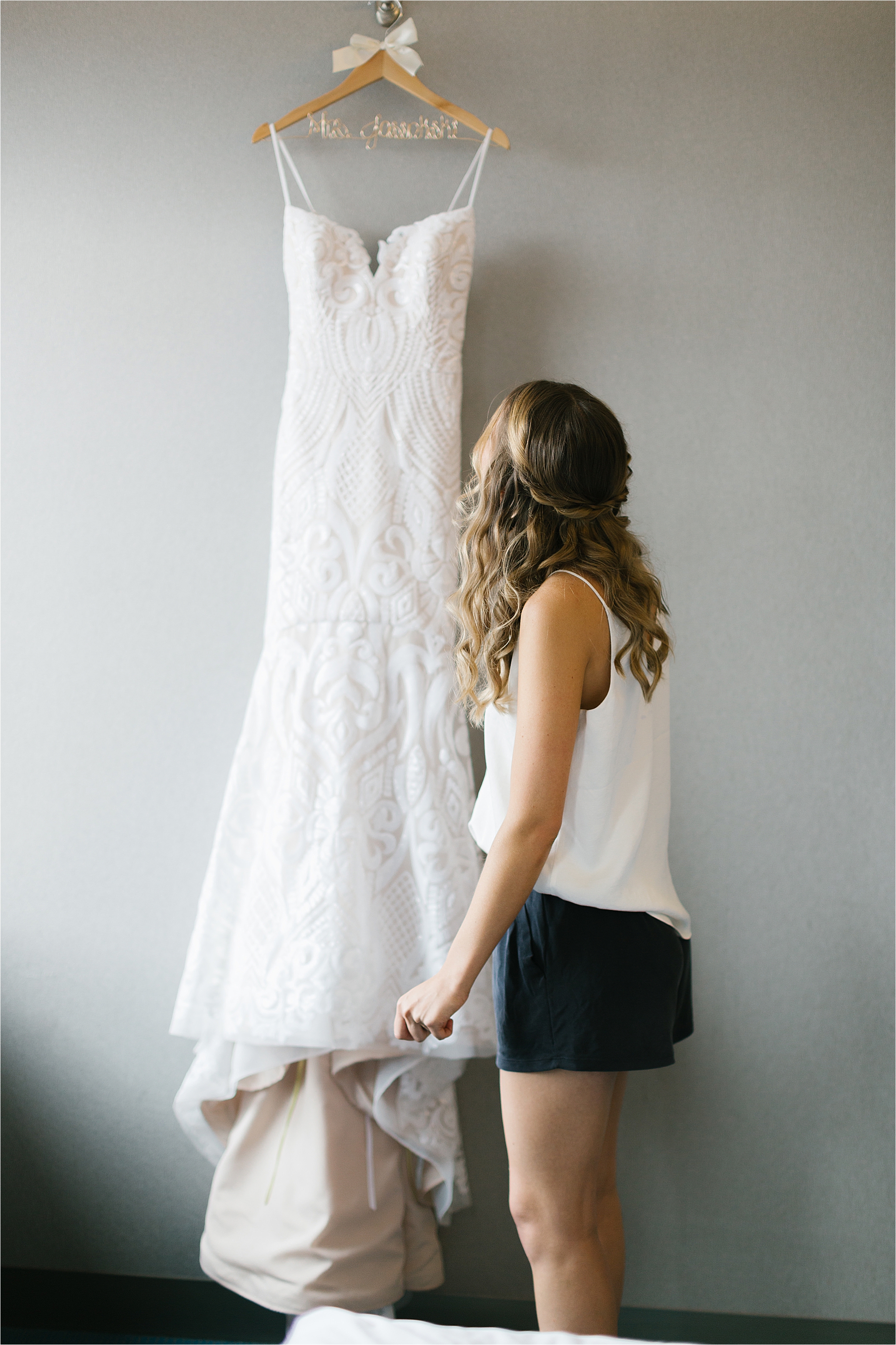 Cleveland bride looking at beaded blush Miss Hayley Paige wedding gown