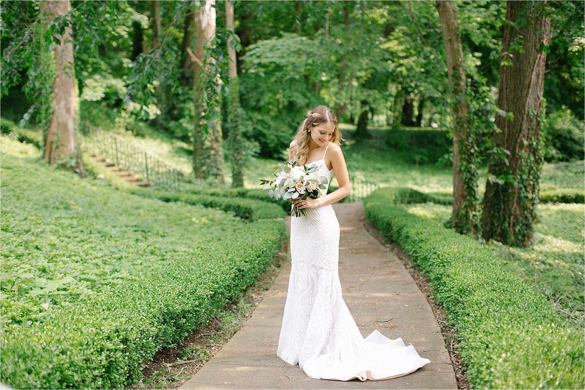 Bride wearing beaded blush hayley paige wedding dress in the Cleveland cultural gardens