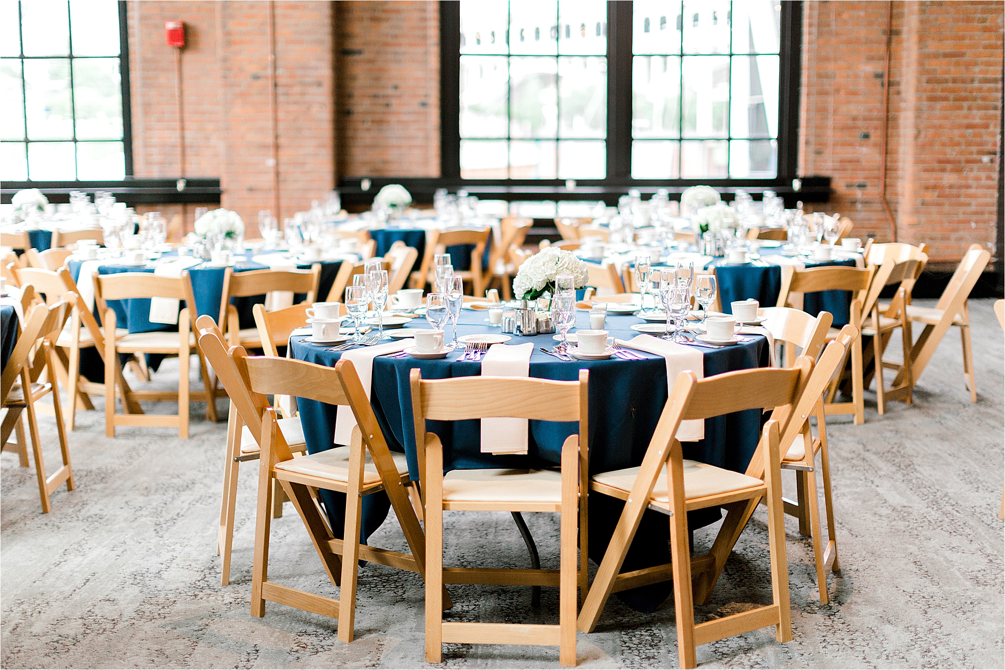 brown chairs at industrial cleveland wedding venue windows on the River