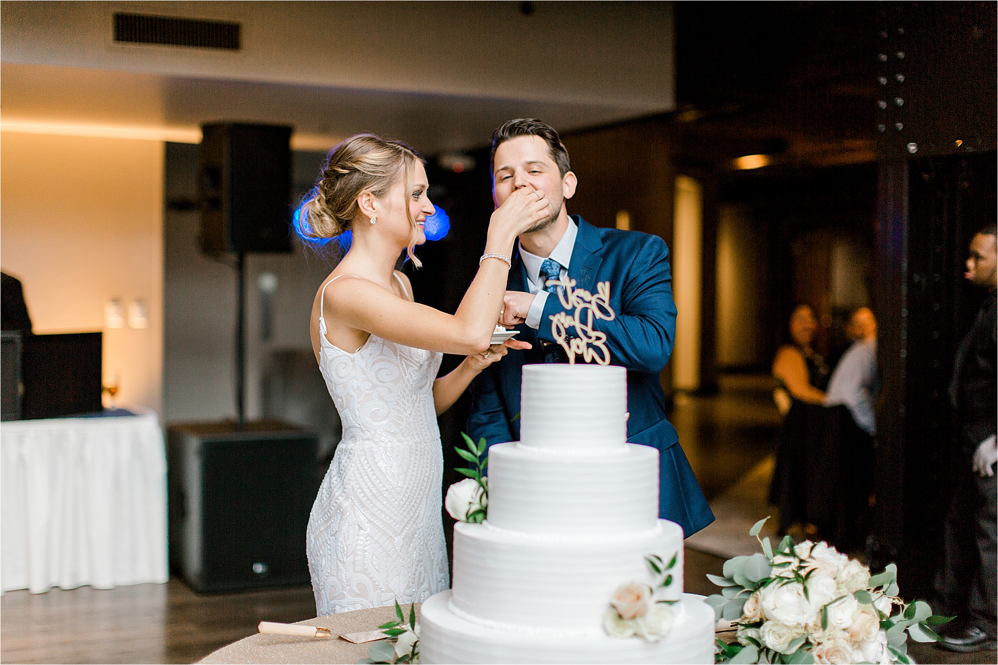 Bride and groom cutting cake by Wild Flour Bakery at Windows on the River