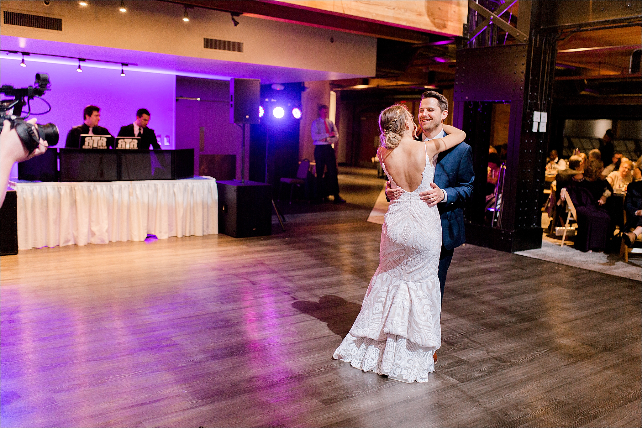 Bride wearing blush hayley paige wedding dress dancing with groom at Windows on the River
