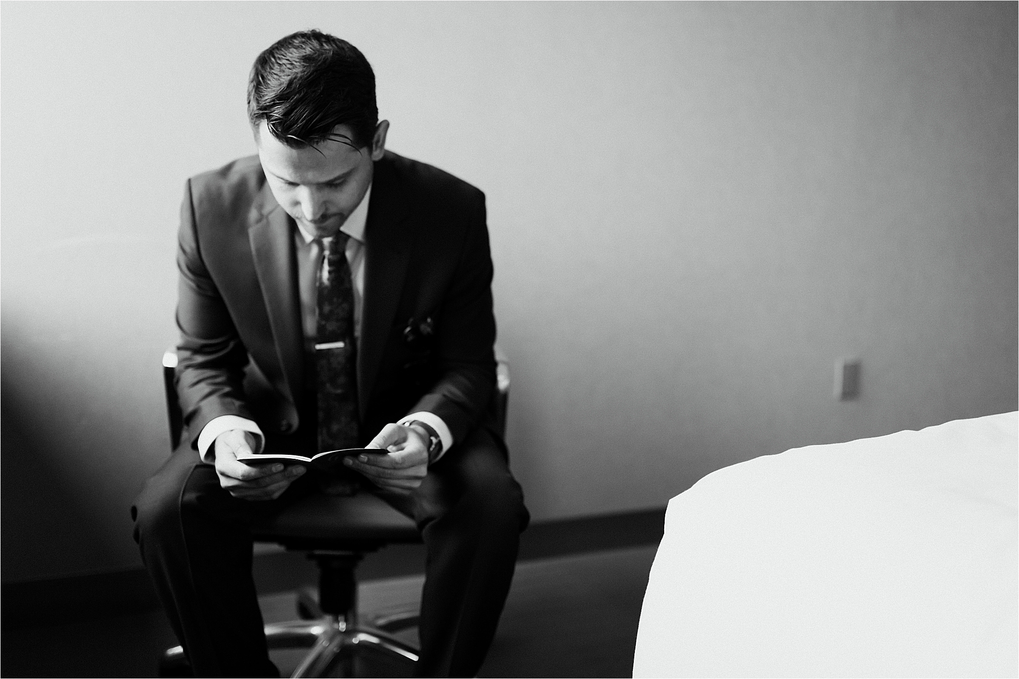 black and white photo of Groom reading vows 