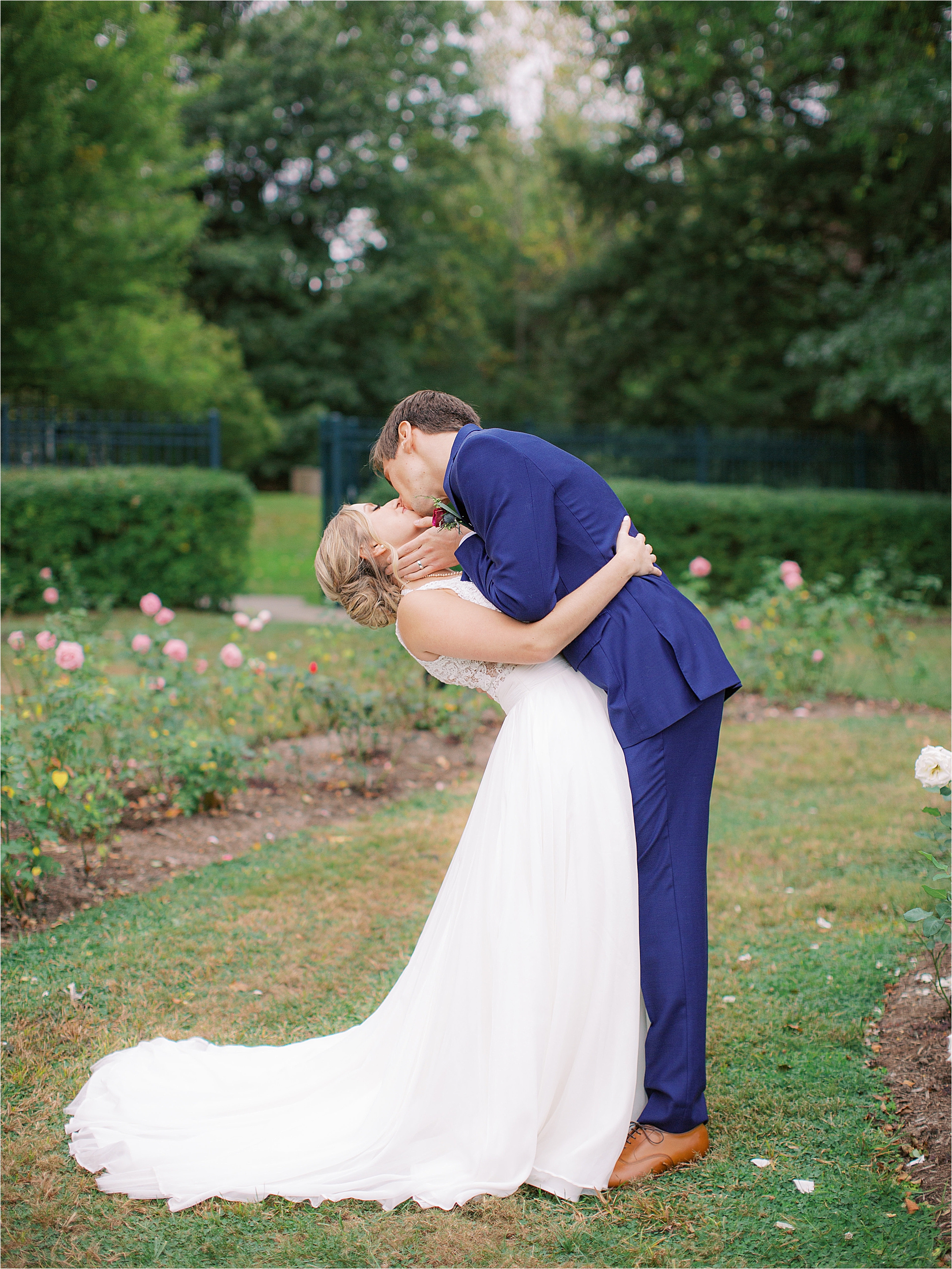 Bride and groom kissing in Mooreland Mansions rose garden 