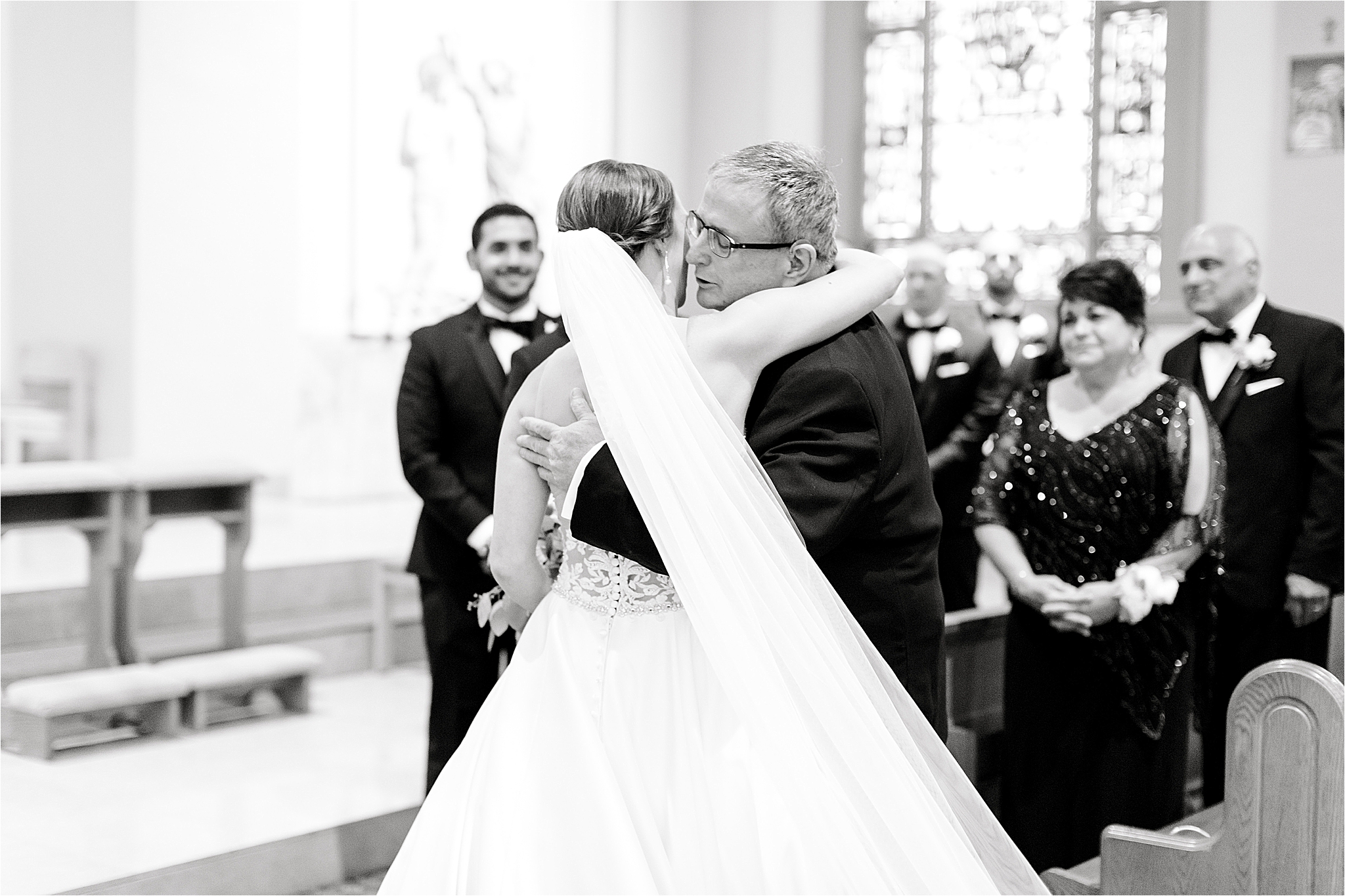 Bride and dad hug during wedding ceremony