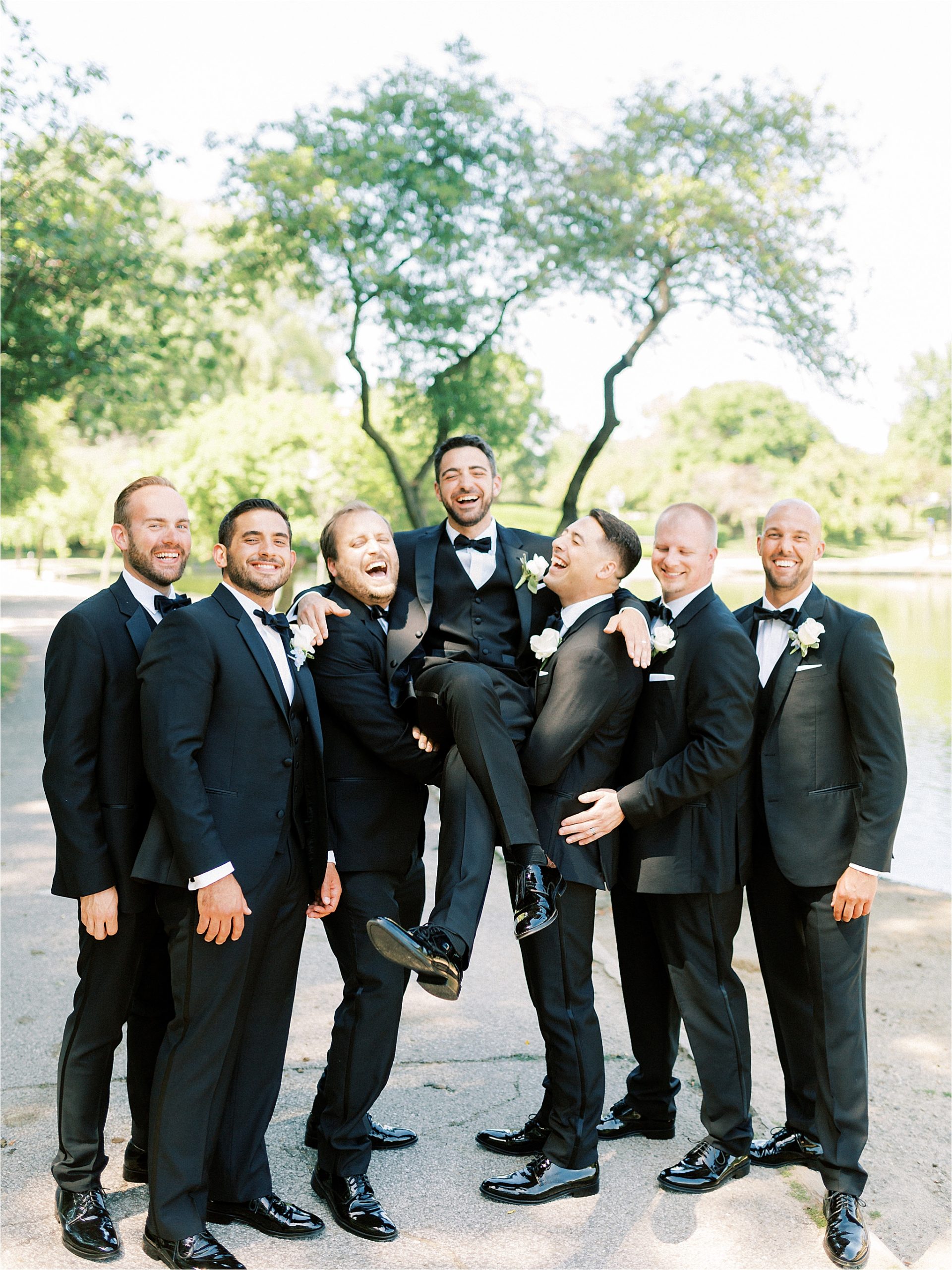 Groomsmen pick up groom at Wade Oval Lagoon at Cleveland Wedding