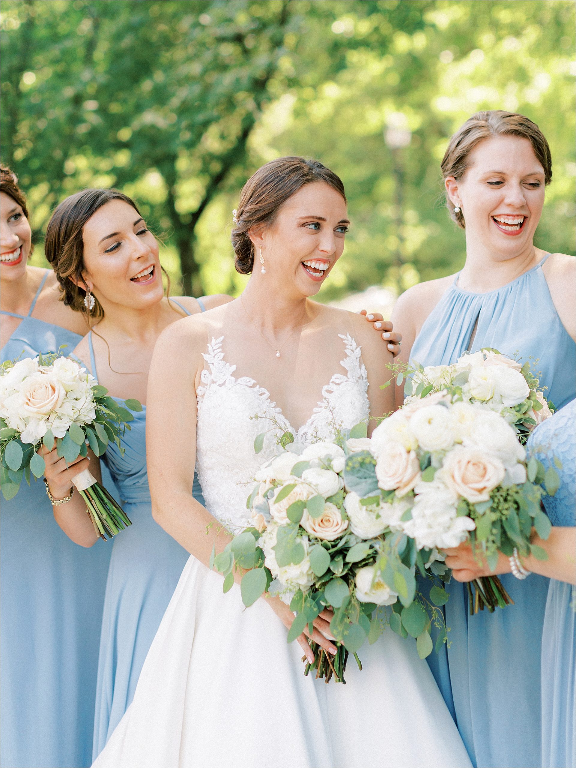 Bridesmaids and Bride wearing light blue azazie dresses