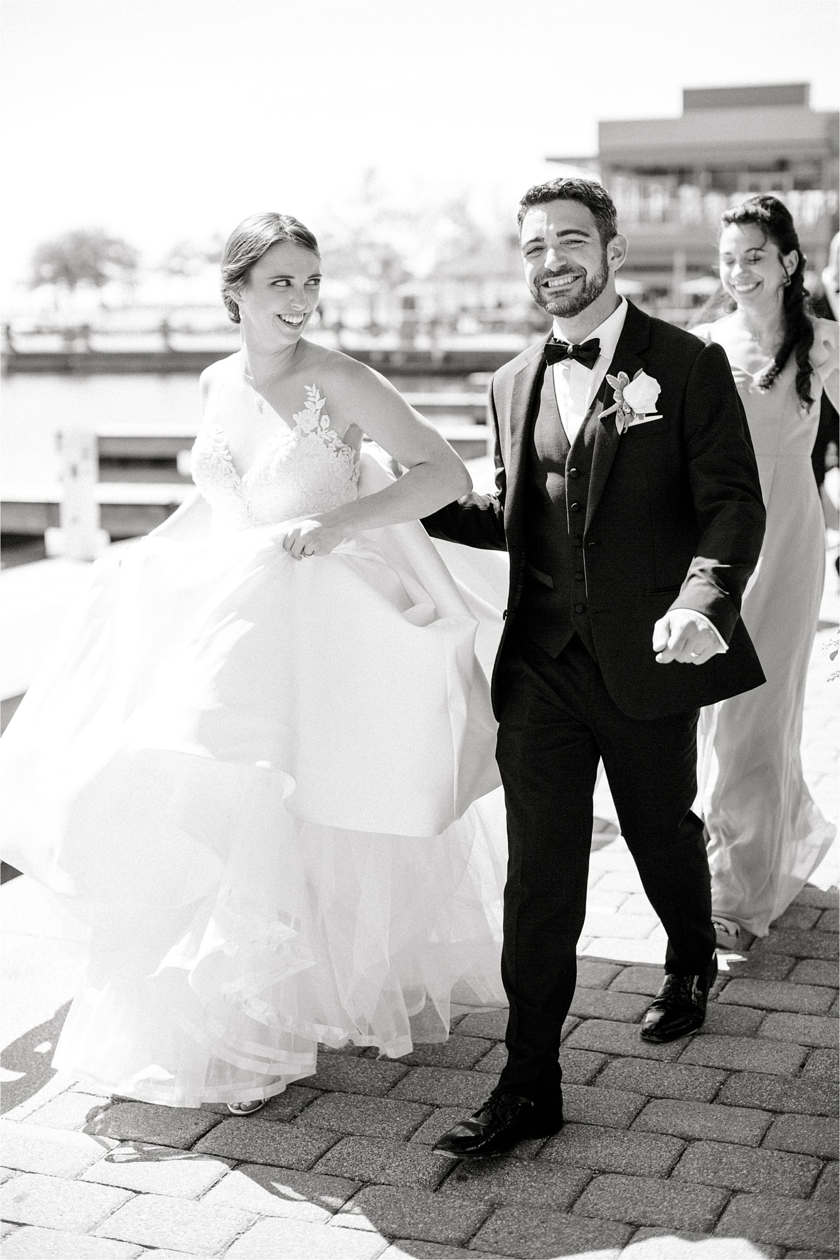 Bride and groom walk on Lake Erie boardwalk at Romantic Cleveland Wedding