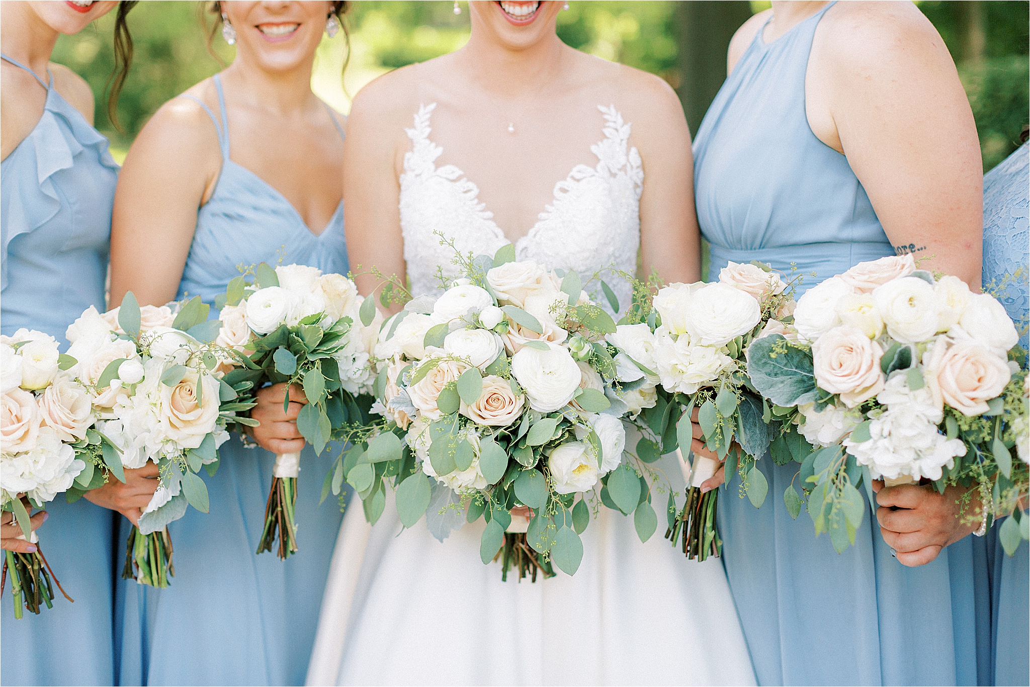 light pink, white, and green bouquets with light blue bridesmaid dresses