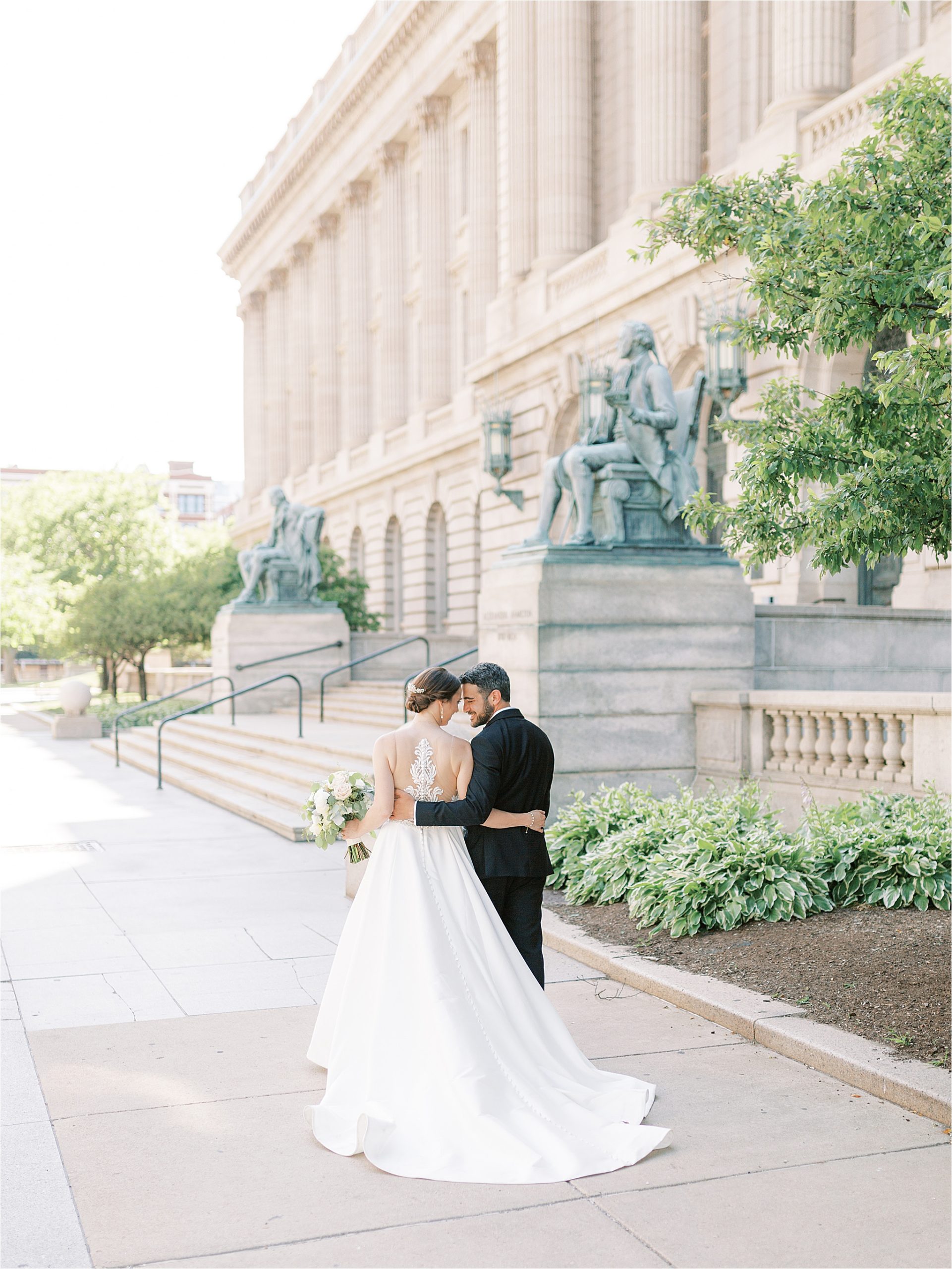 Bride and groom walk away in front of Old Courthouse in Cleveland Ohio